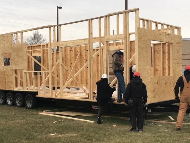 people building a tiny house