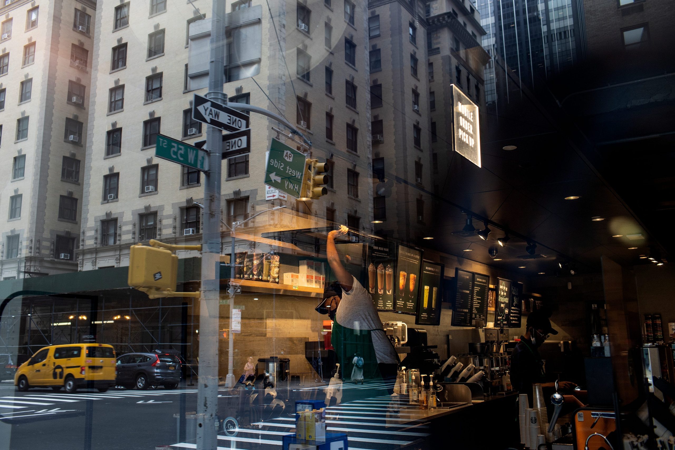 A Manhattan street corner with a Starbucks in view.