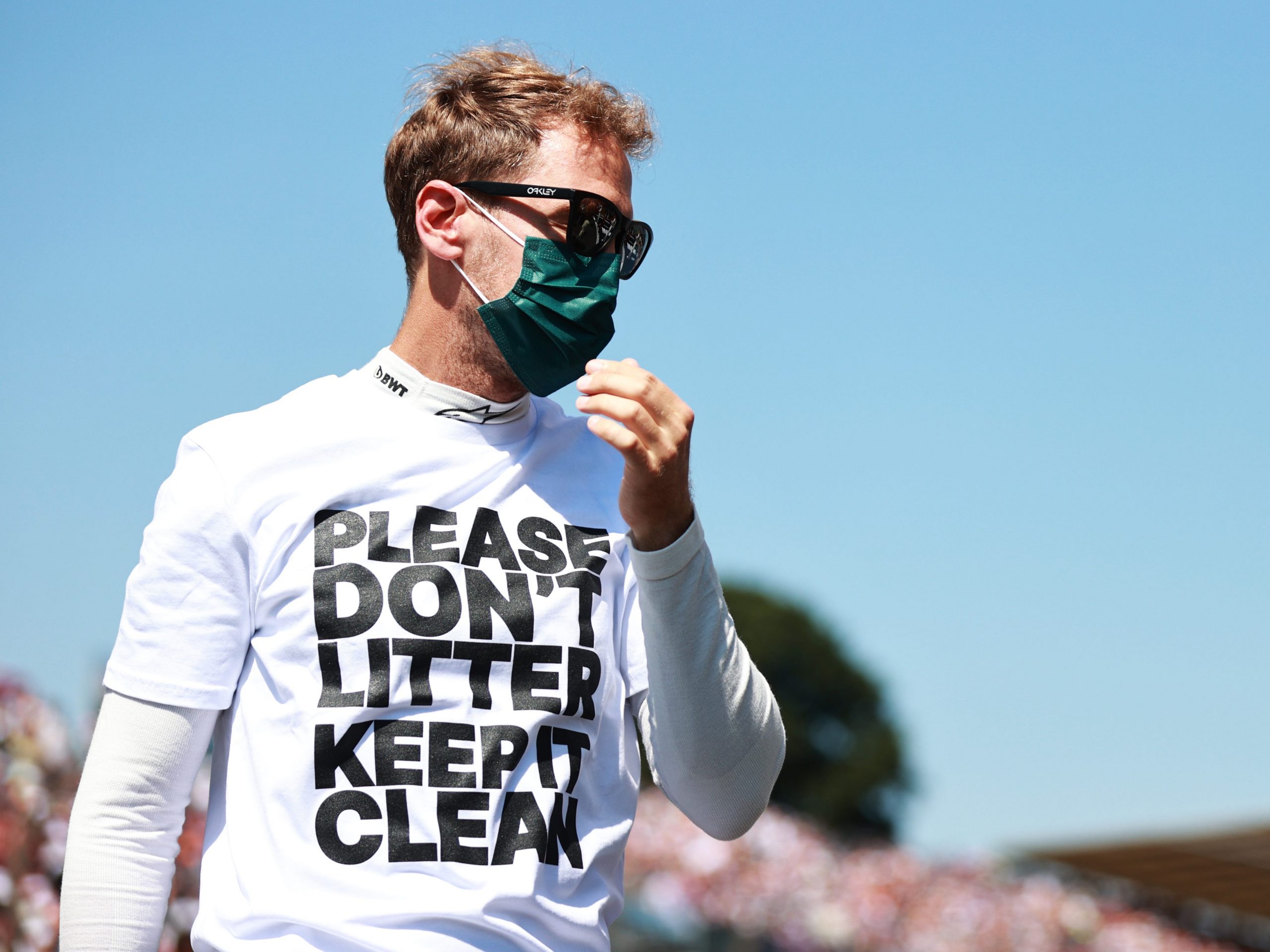 Formula One driver Sebastian Vettel wearing a T-shirt reading "Please don't litter, keep it clean" before the British Grand Prix