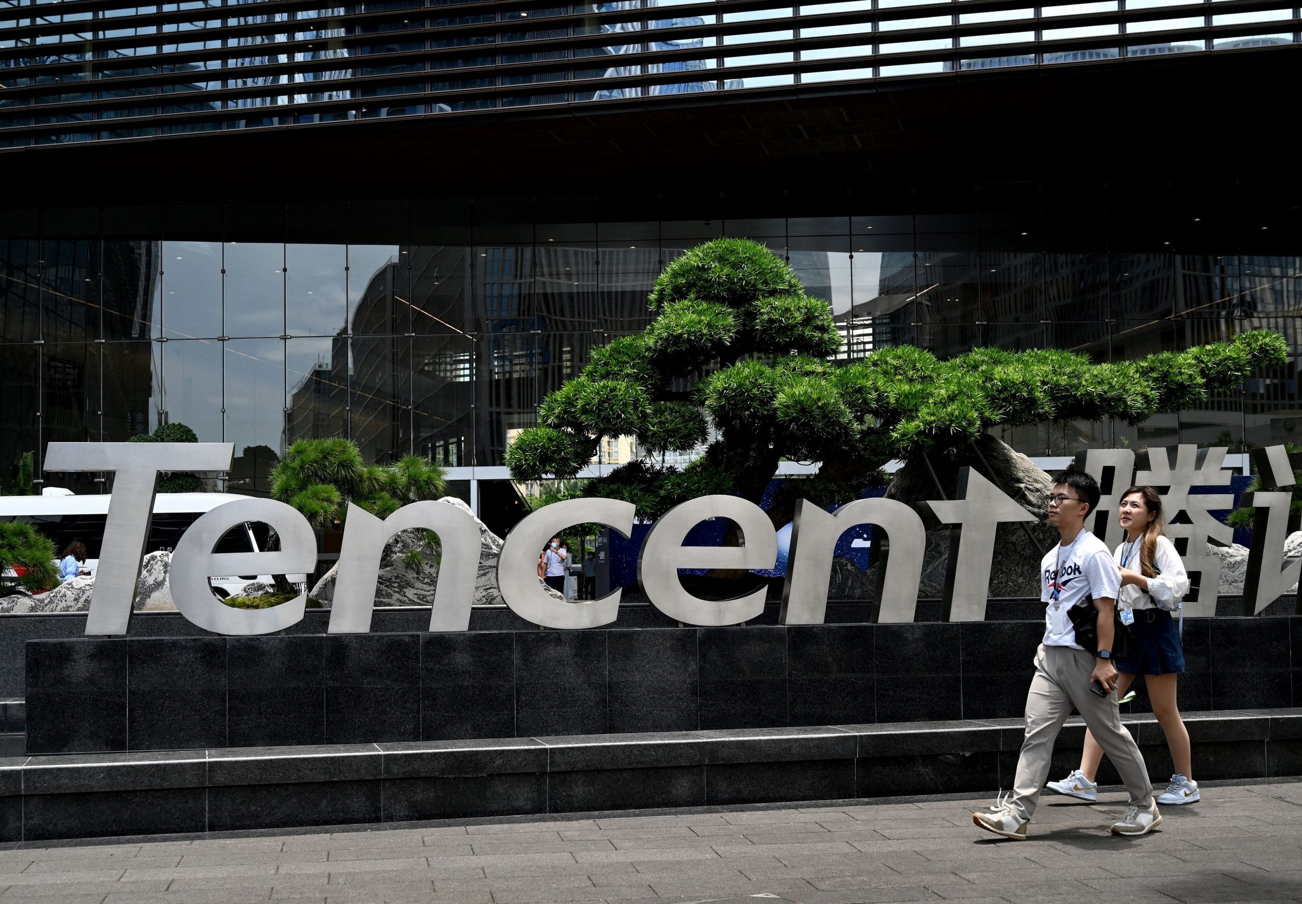 People walking past the Tencent headquarters in the southern Chinese city of Shenzhen.