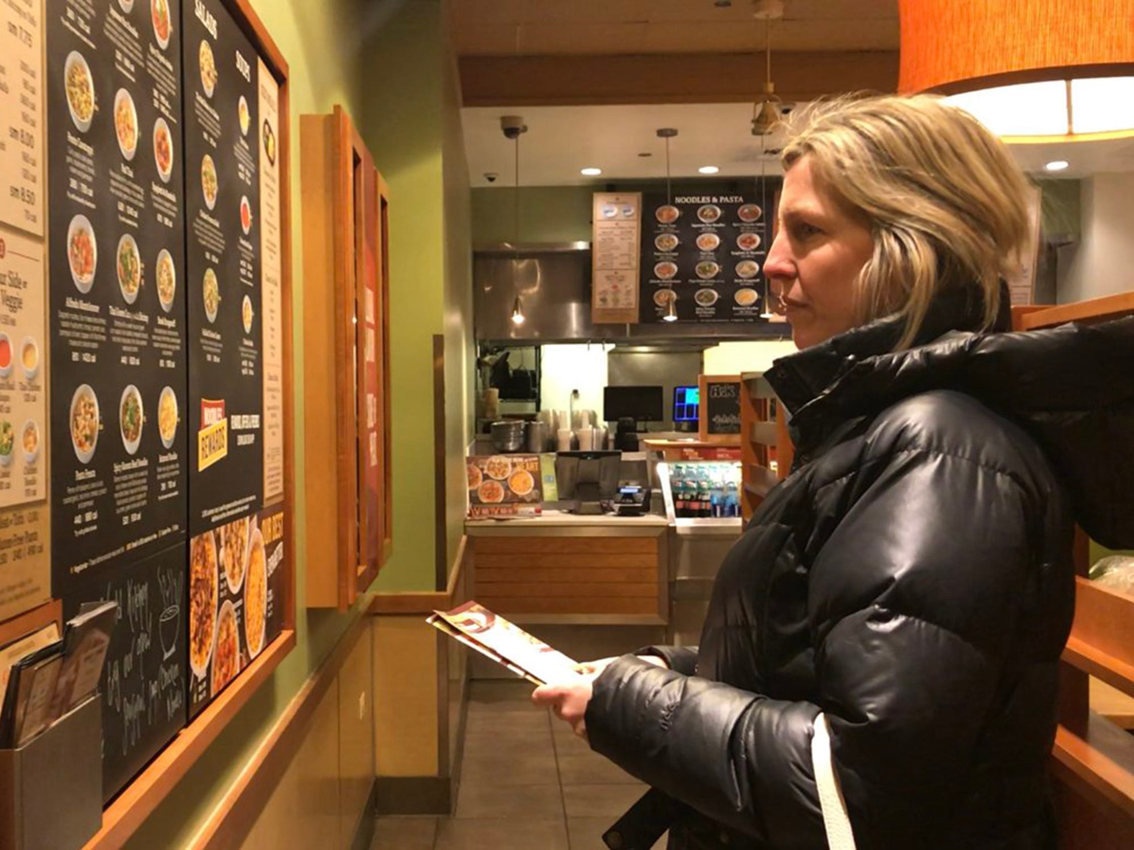 Woman looks at panda express menu