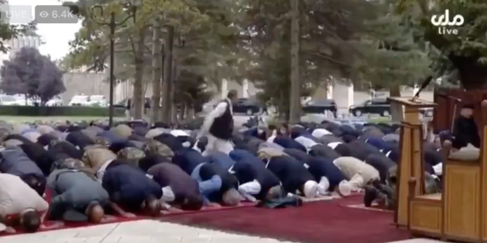 A video still of people praying
