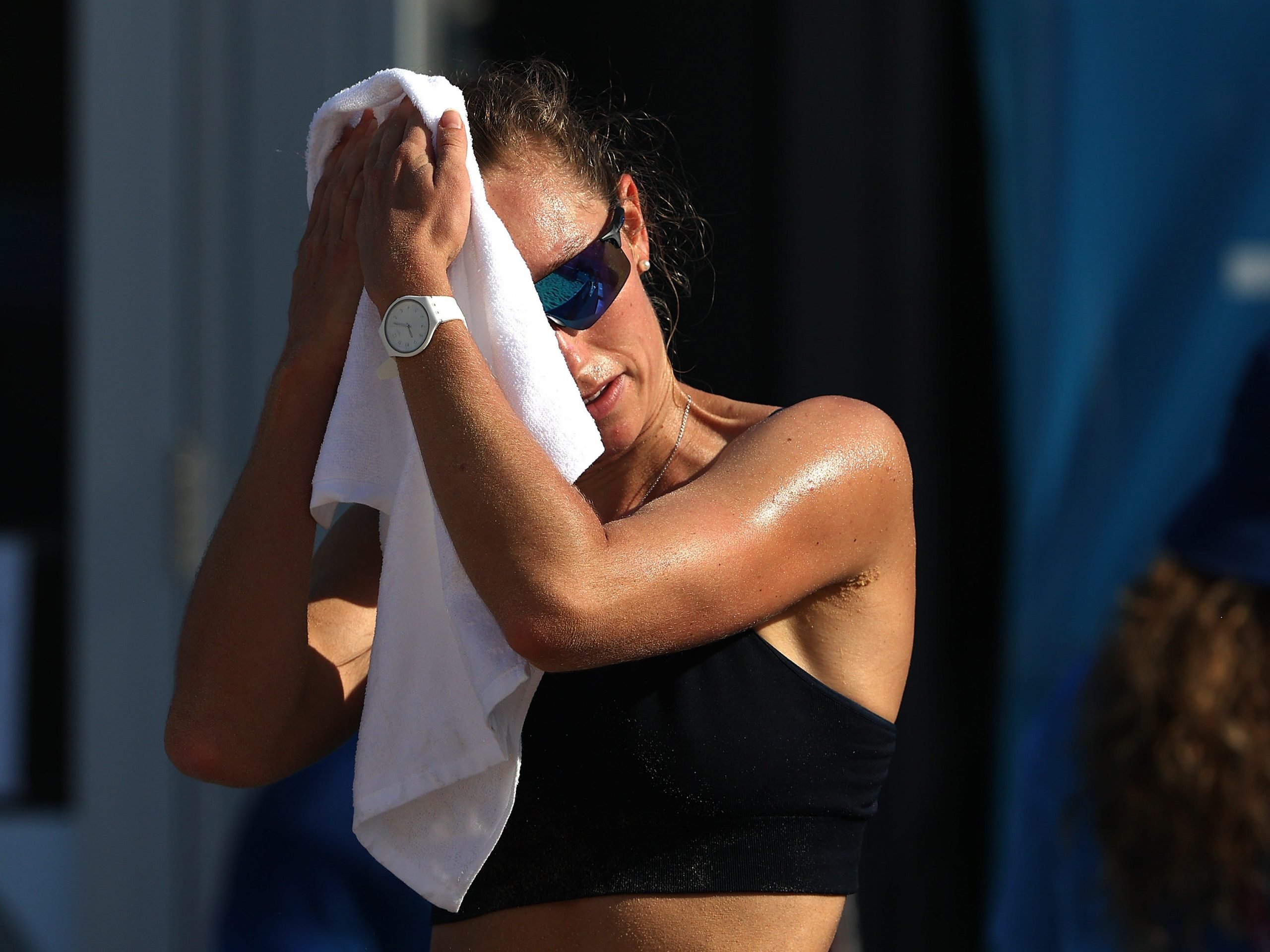 ina Betschart of Team Switzerland Women's Beach Volleyball uses a towel to cool down while training at Shiokaze Park ahead of the Tokyo 2020 Olympic Games