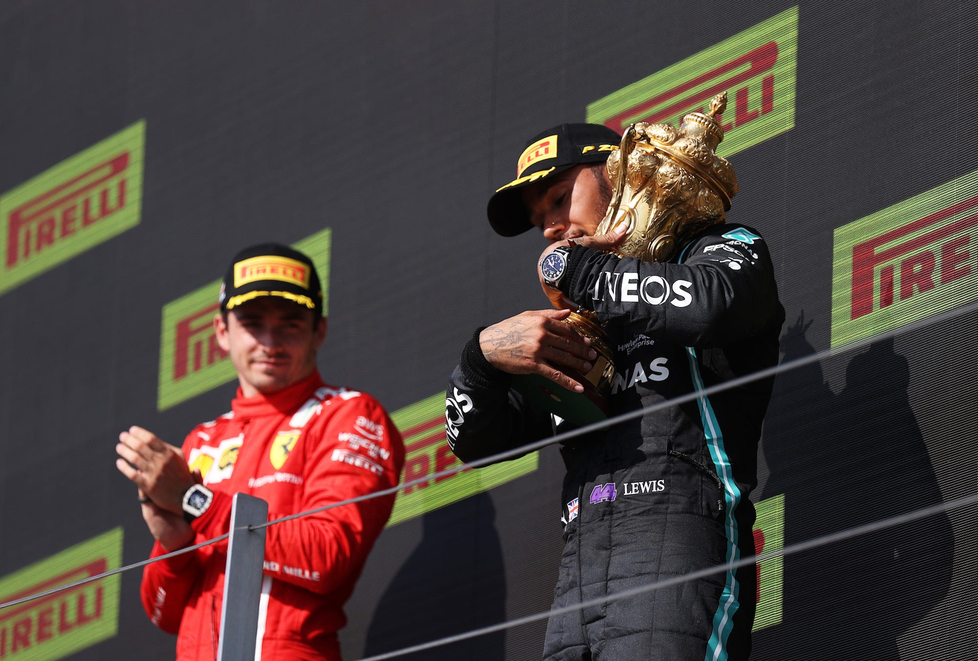 Race winner Lewis Hamilton of Great Britain and Mercedes GP and second placed Charles Leclerc of Monaco and Ferrari celebrate on the podium during the F1 Grand Prix of Great Britain at Silverstone on July 18, 2021