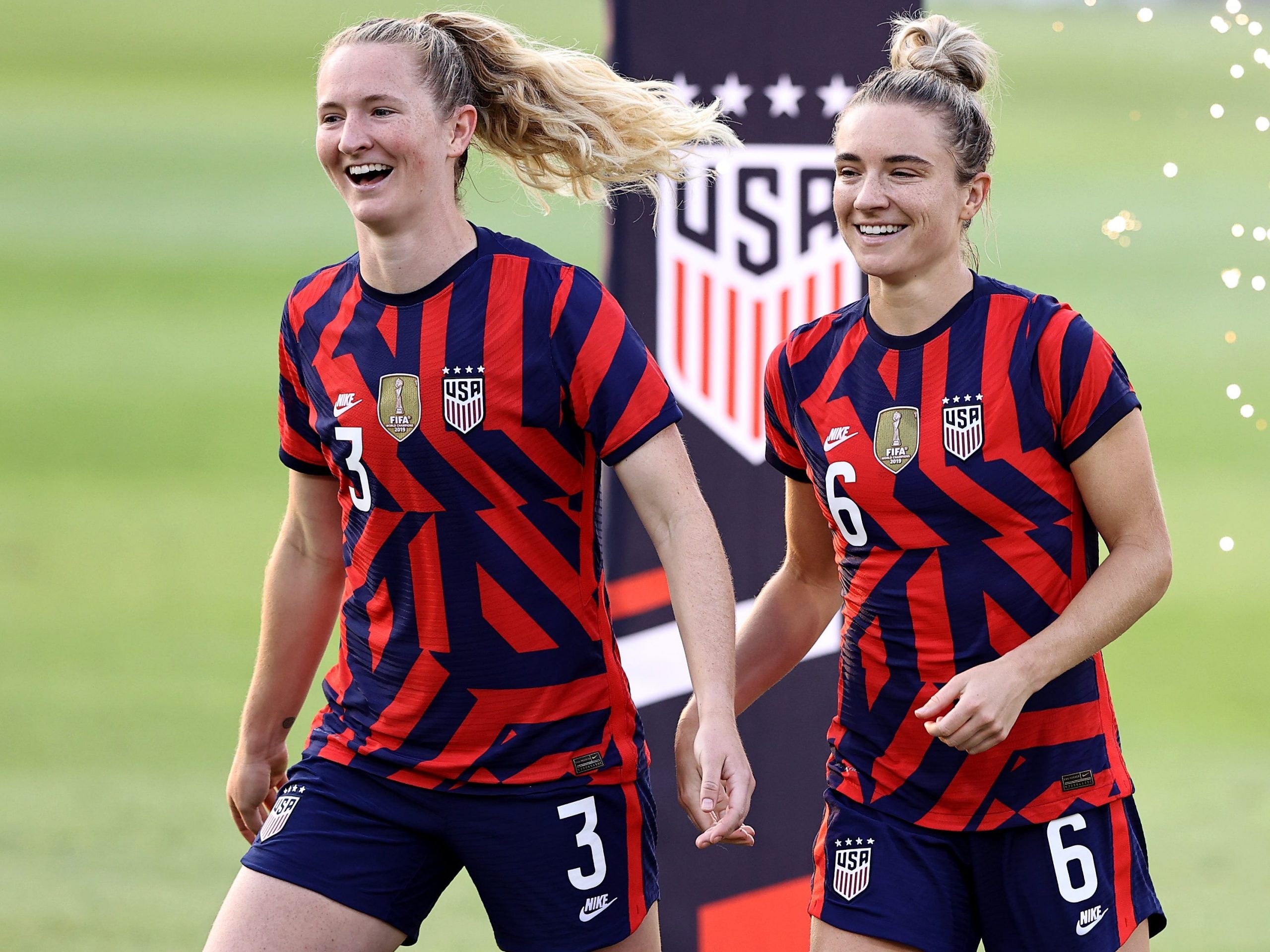 Samantha and Kristie Mewis on a soccer field