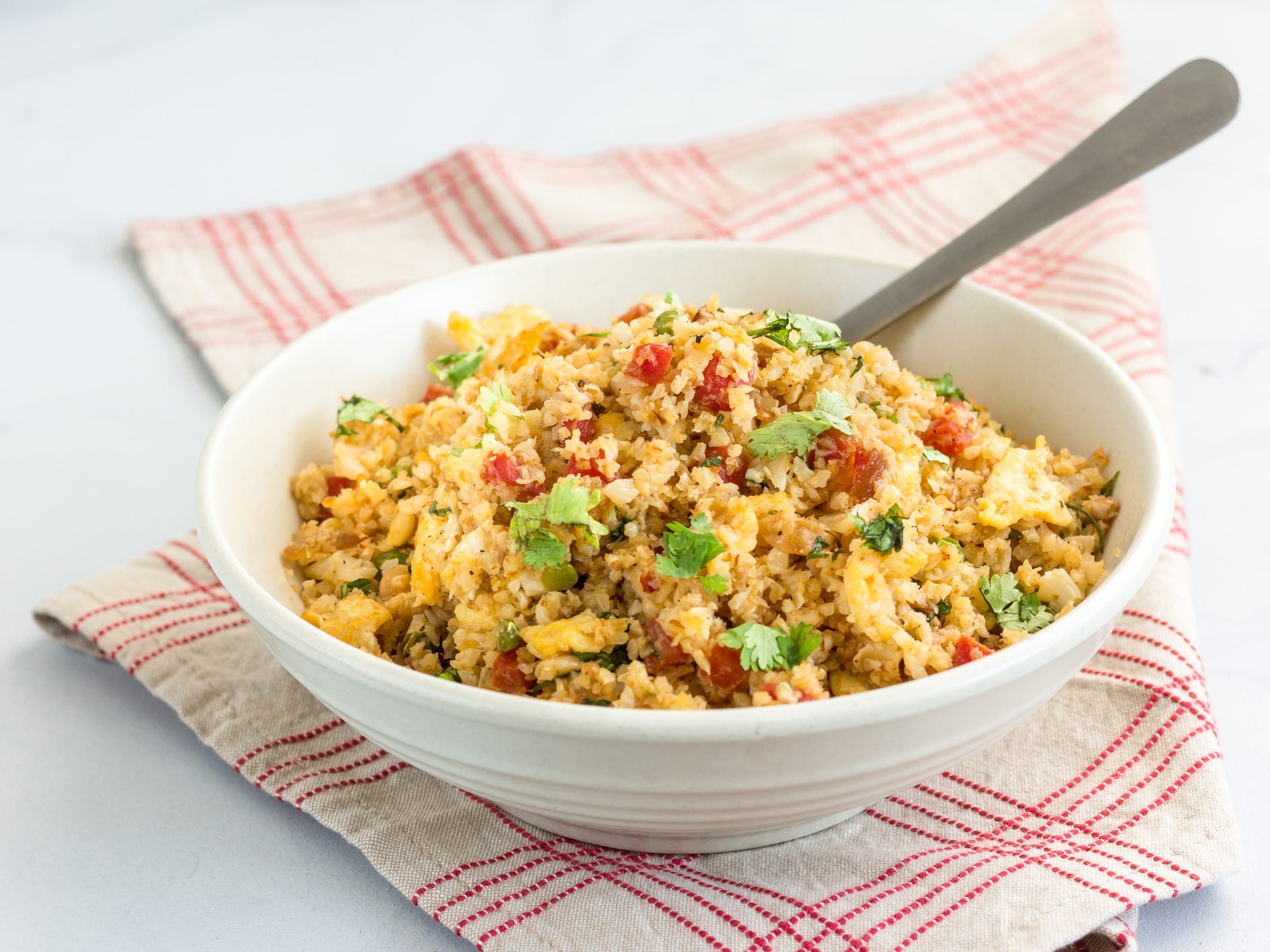 A bowl of fried rice made with cauliflower rice as the base