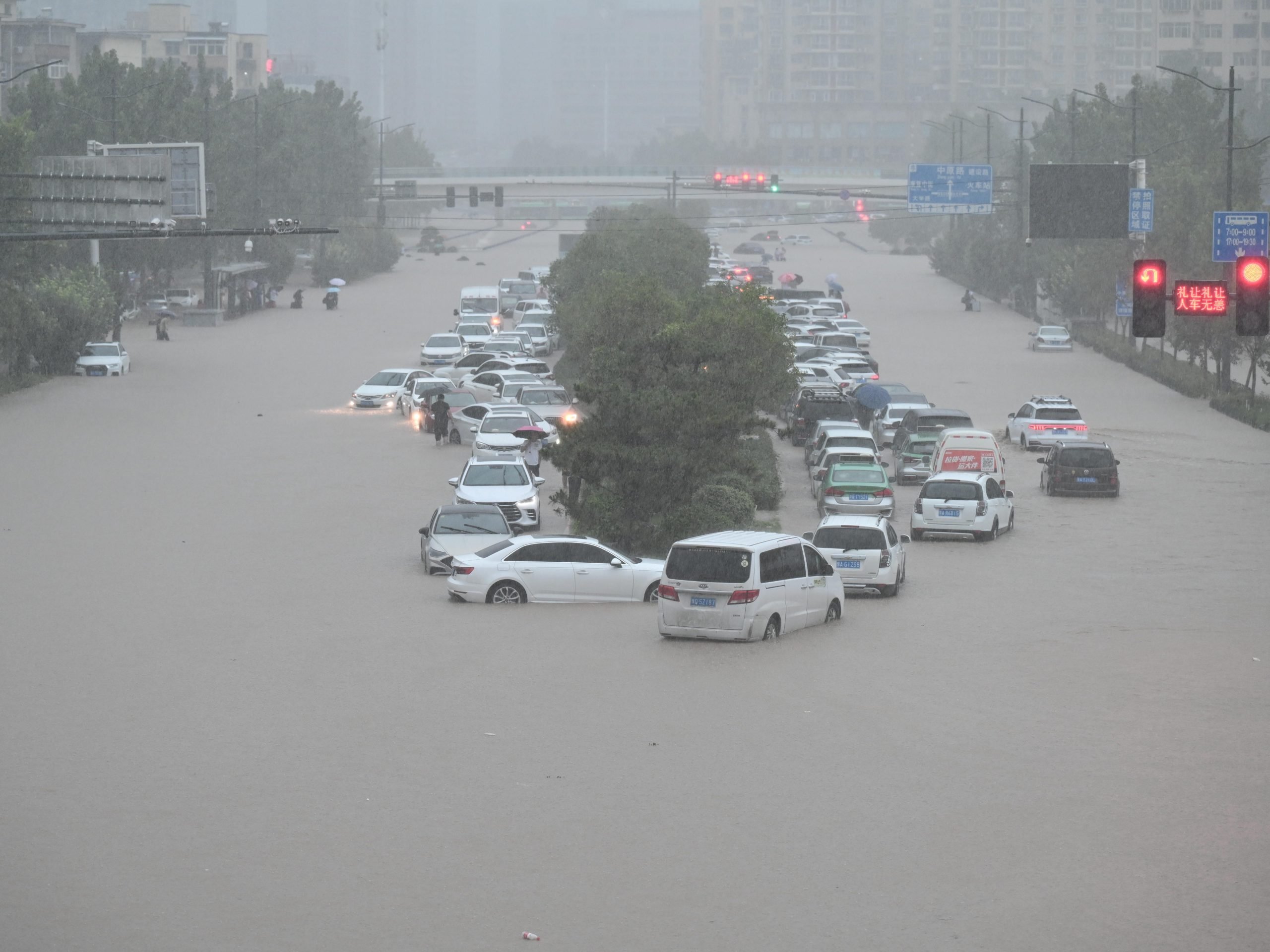 Vehicles are stranded in floodwater near Zhengzhou Railway Station, July 20, 2021.