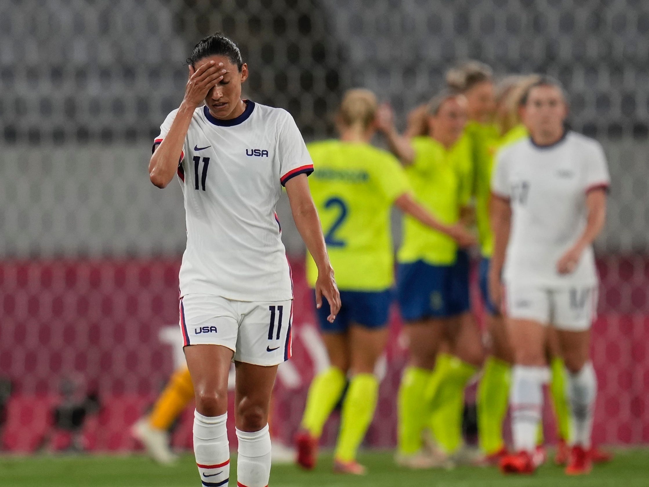 Christen Press reacts after Sweden scores its third goal of the Tokyo Olympics opener.