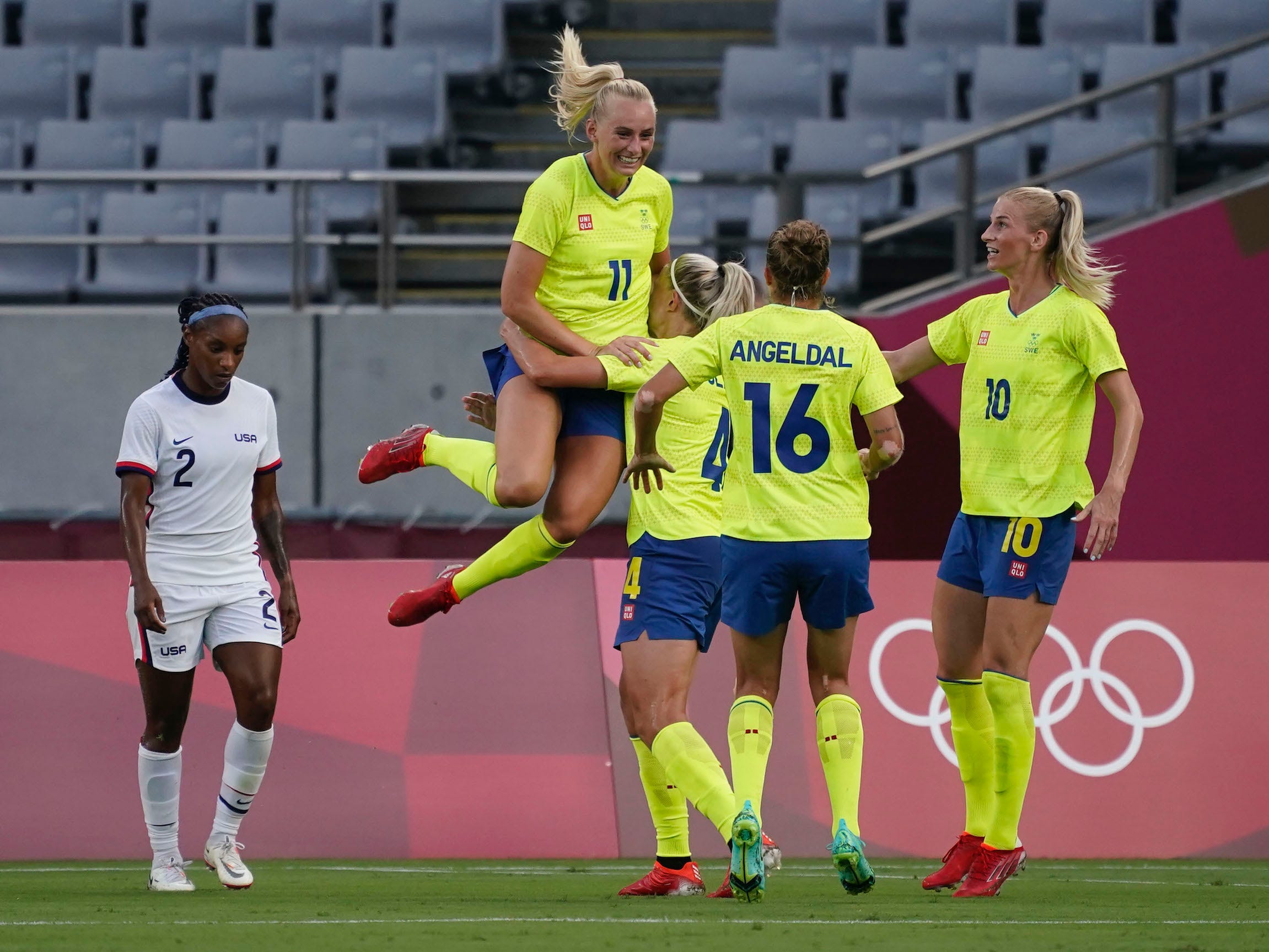 Stina Blackstenius jumps into her teammates' arms in celebration.