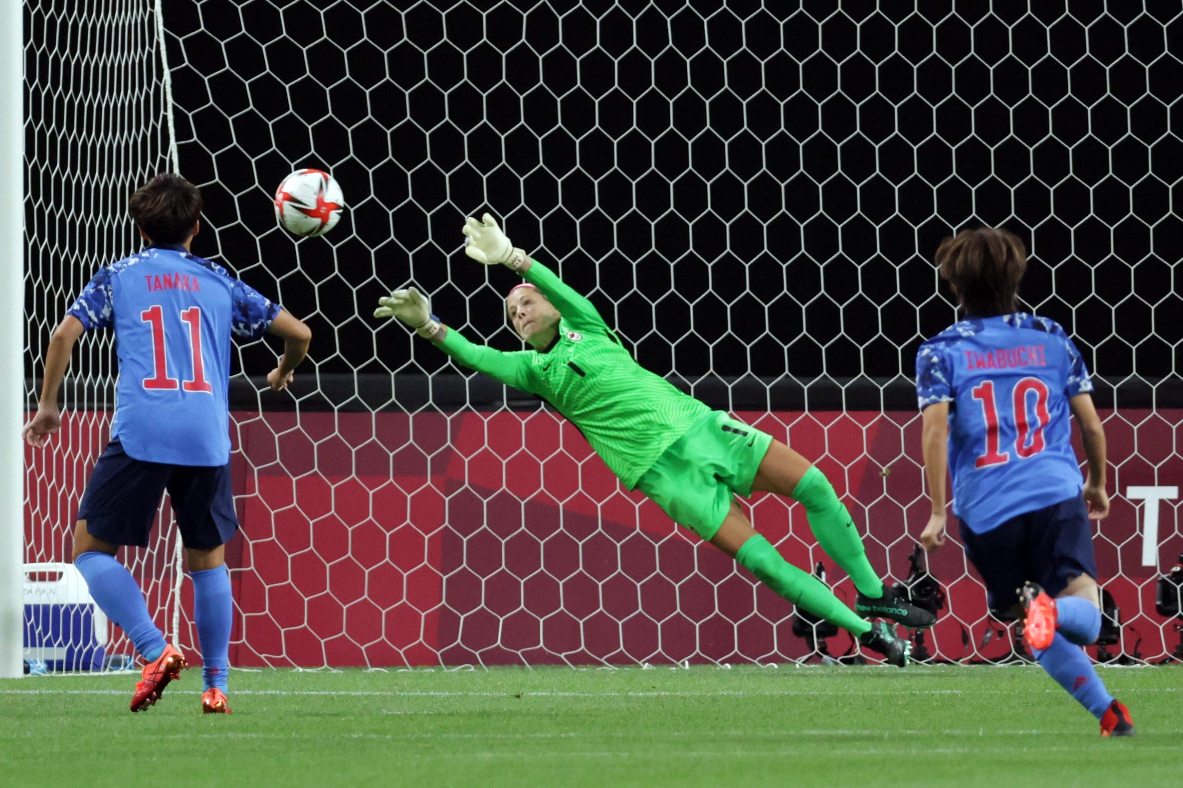 Canada's Stephanie Labbé saves a penalty kick against Japan.