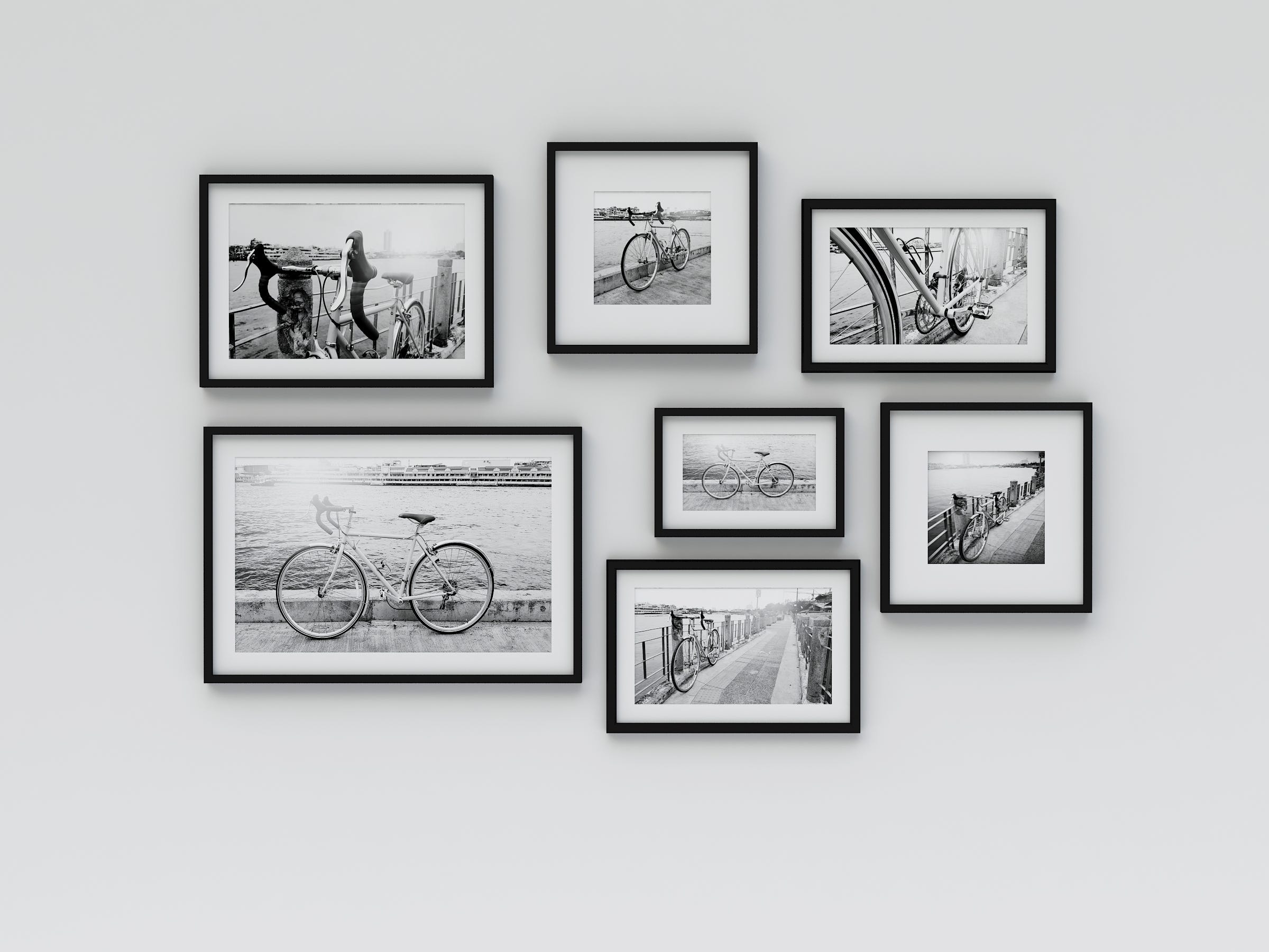 Several frames of black and white images hanging on a wall