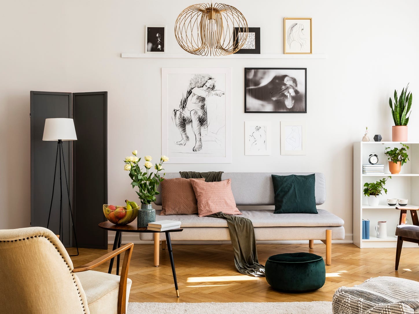 The interior of a living room with art hung above the couch