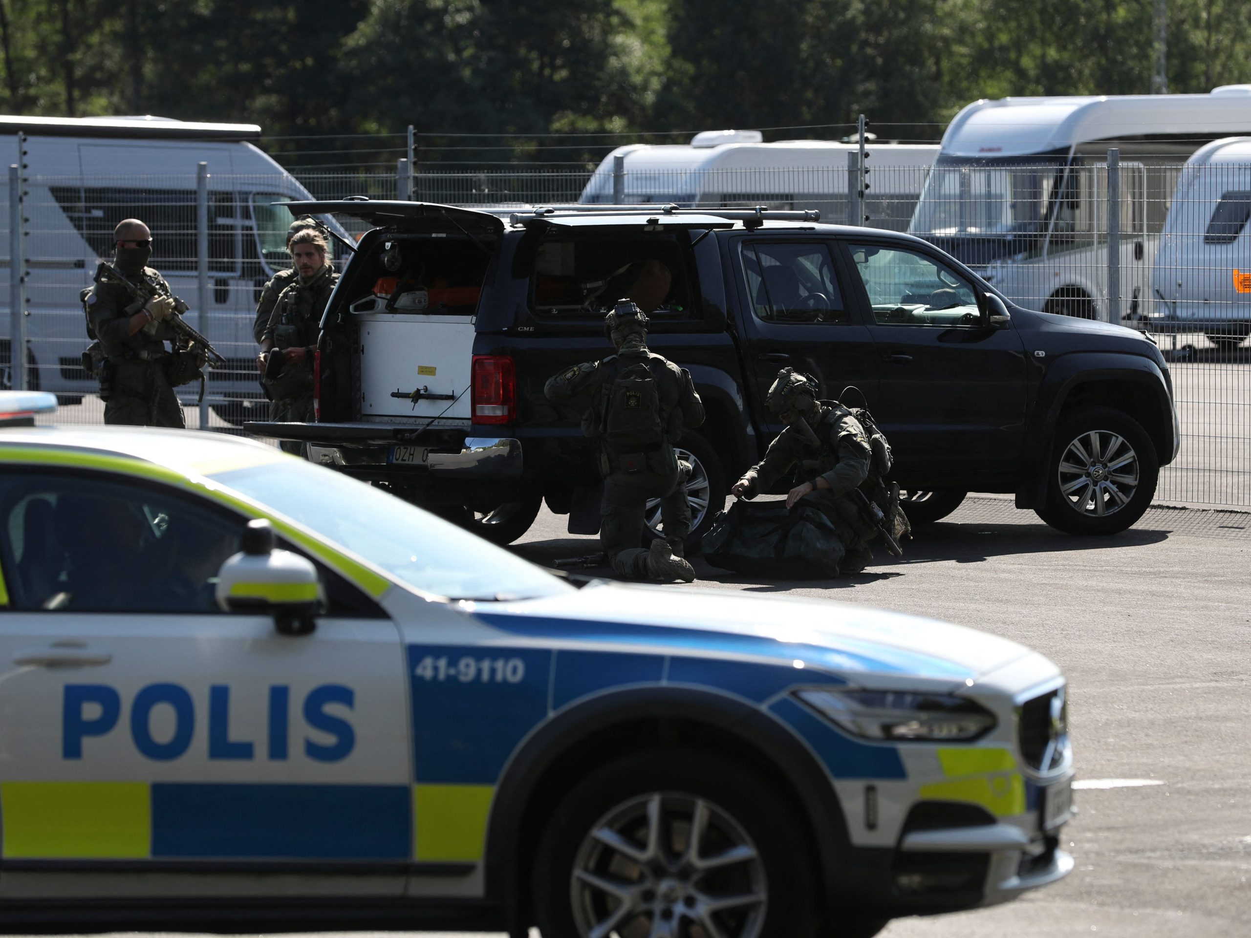 Special unit police forces are seen by a car parked outside the Hallby Prison near Eskilstuna, Sweden, July 21, 2021.