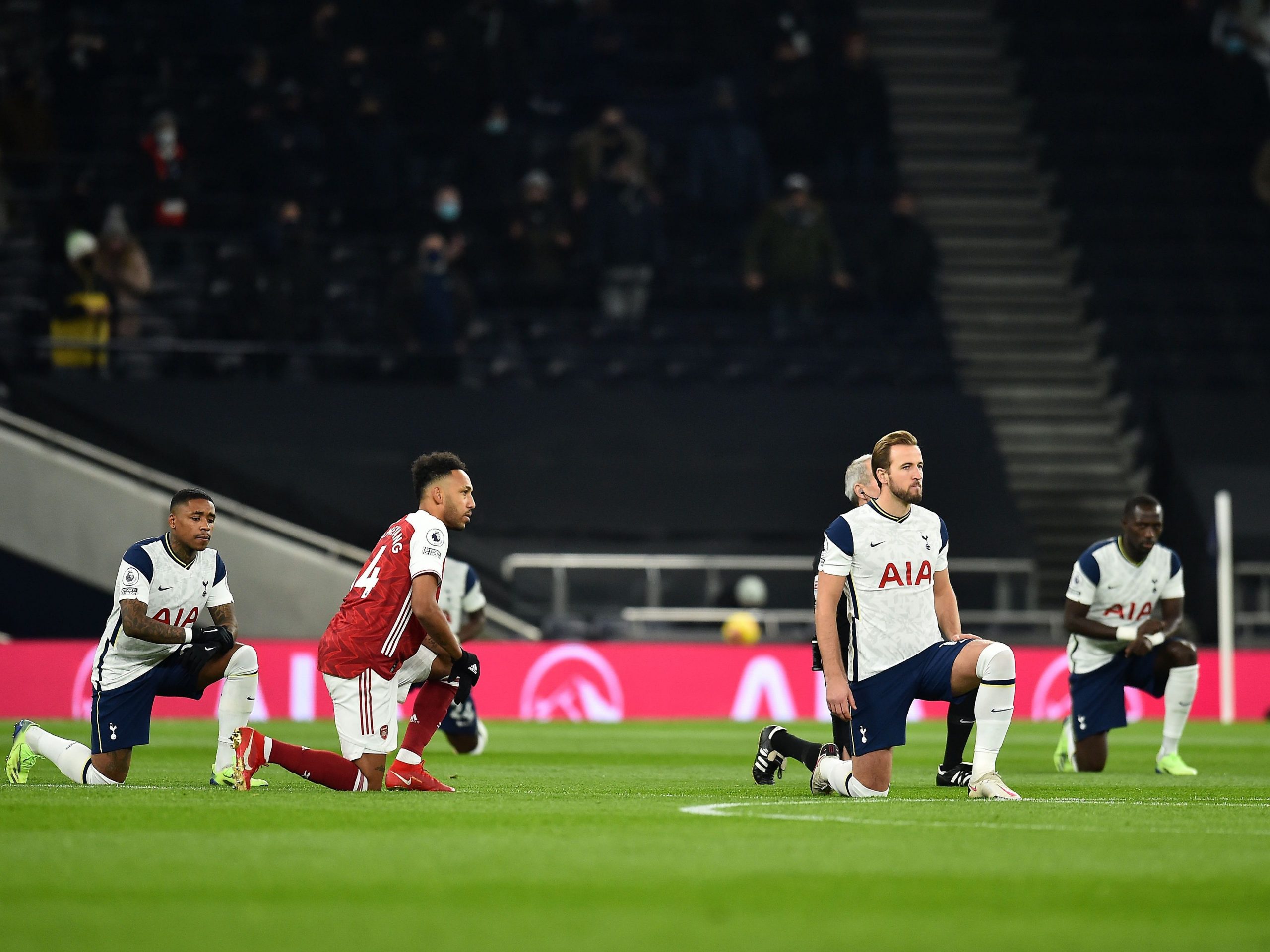 Arsenal and Tottenham Hostpur players kneel before their Premier League match