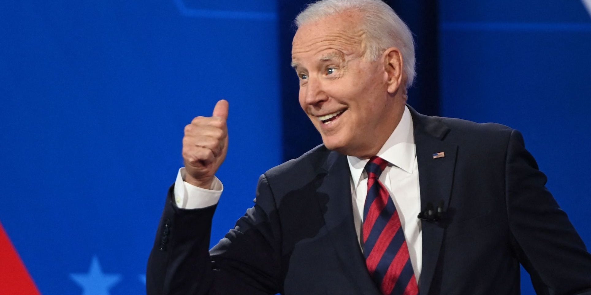 Joe BIden points his thumb behind him in a gesture at a CNN town hall.