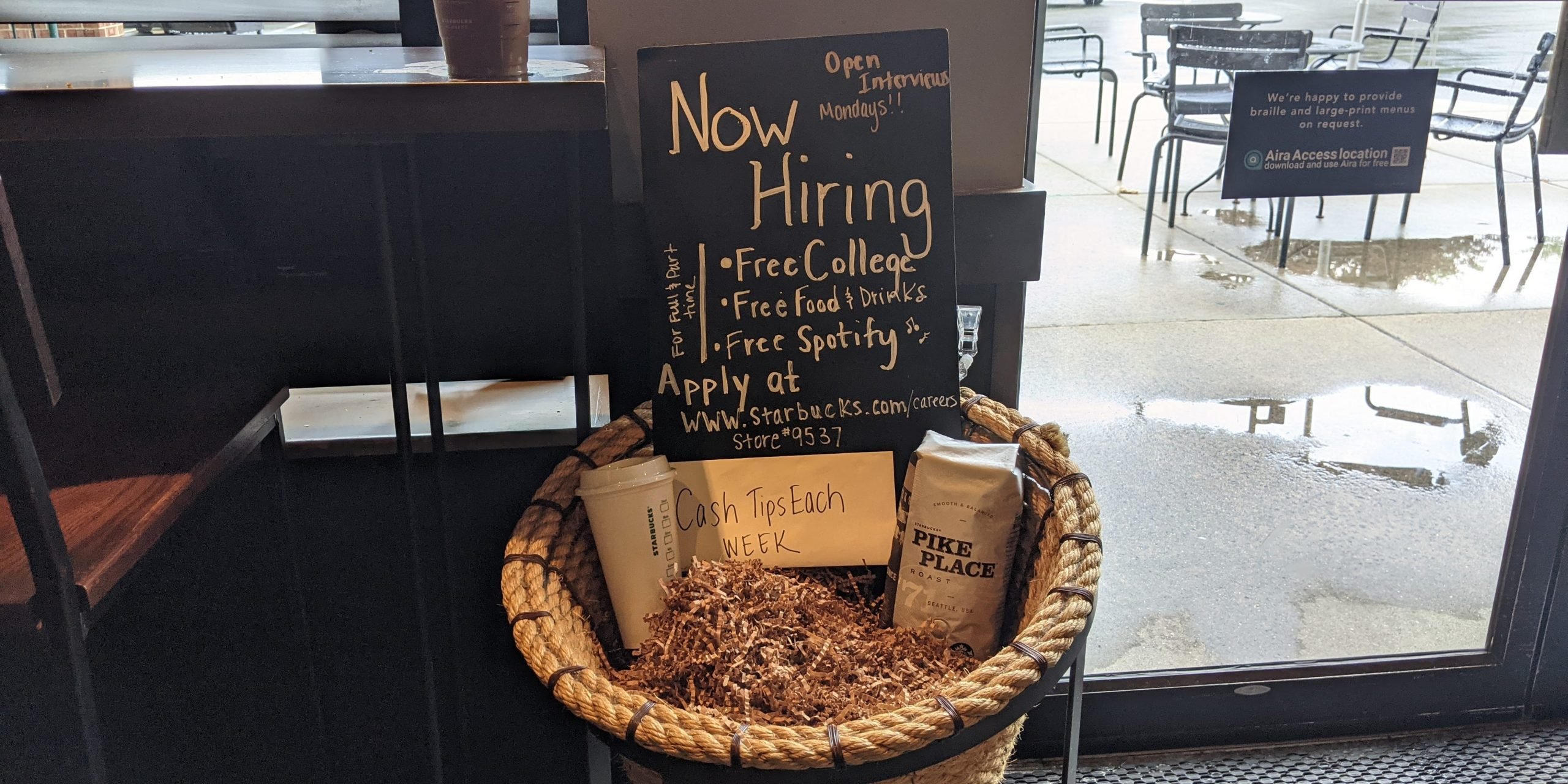 Starbucks "Now Hiring" sign seen at Wyomissing, Pennsylvania area Starbucks coffee shop.