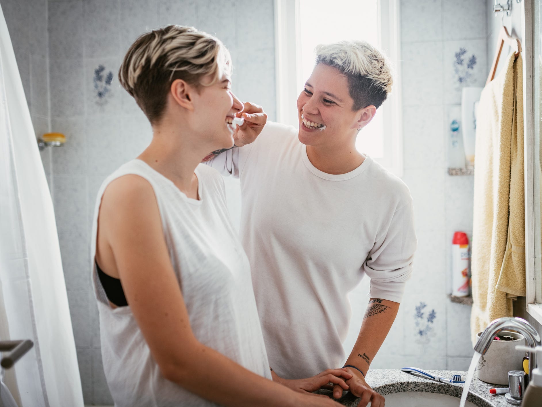 Queer couple brushing each other's teeth