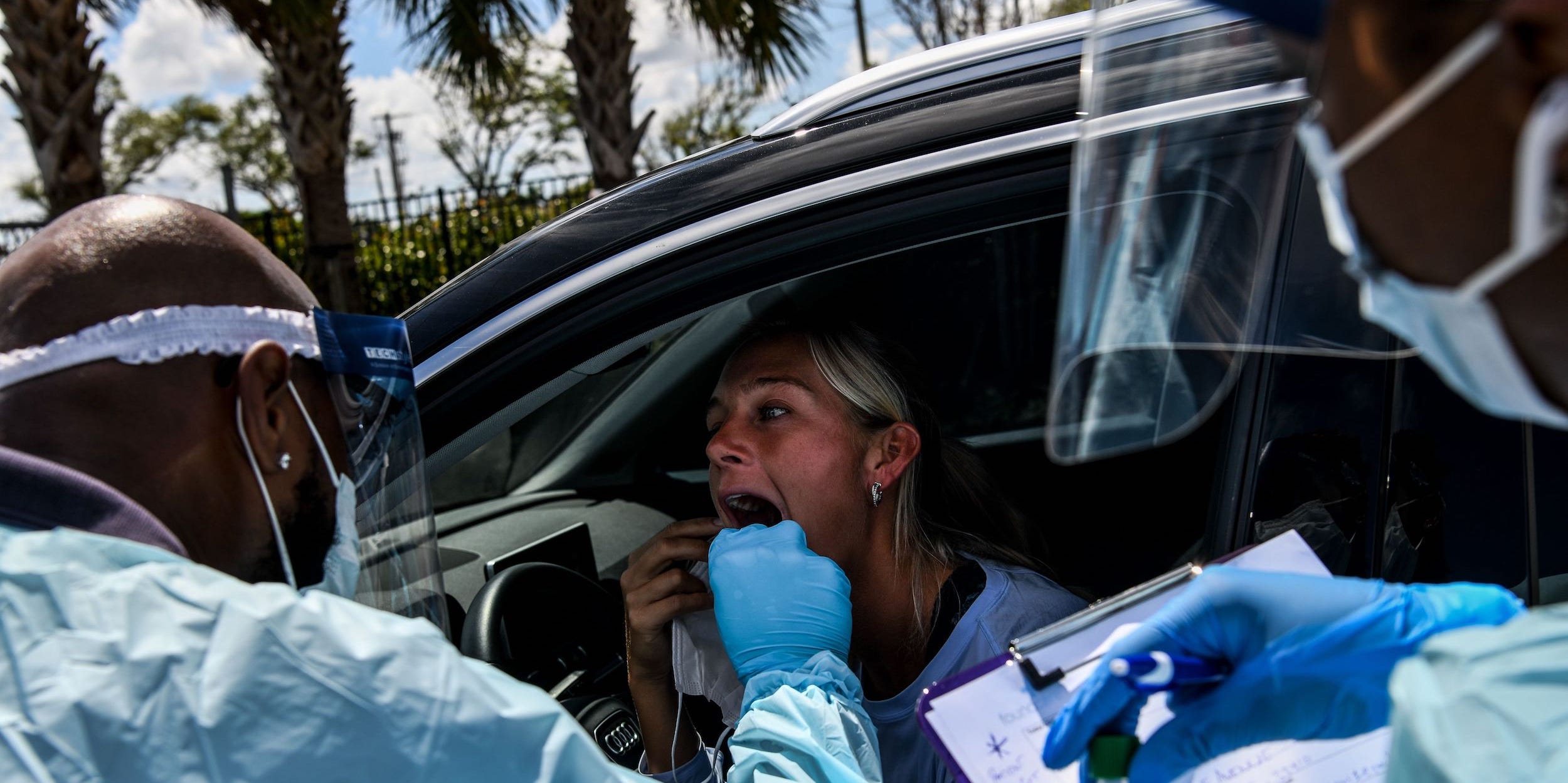A Florida woman ireceives a coronavirus test in her car.