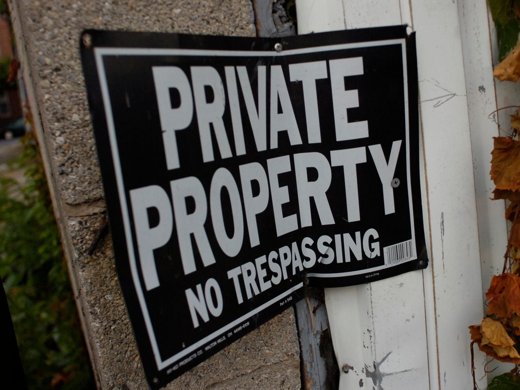 A black sign with "private property" written in white letters.