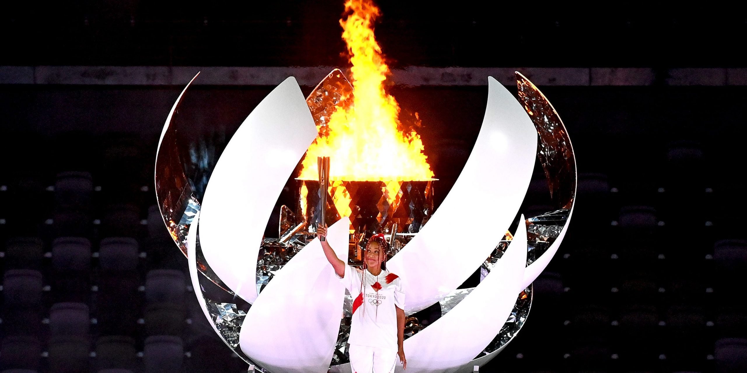 Naomi Osaka of Team Japan lights the Olympic cauldron with the Olympic torch during the Opening Ceremony of the Tokyo 2020 Olympic Games