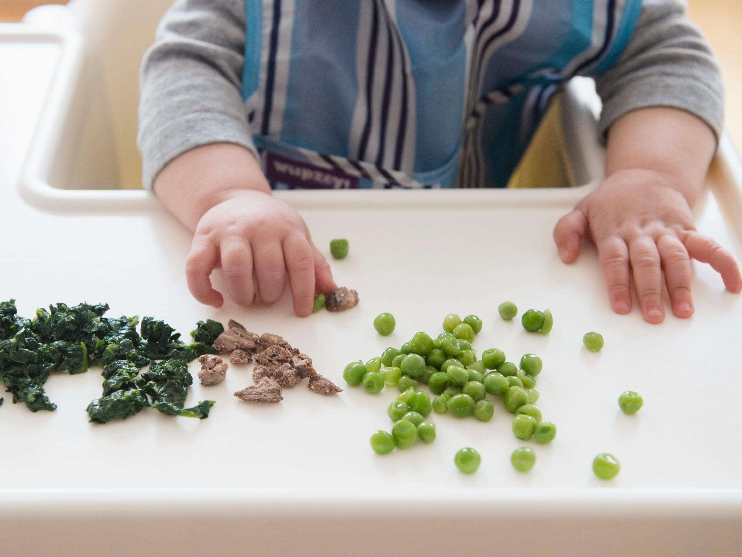 Baby eating assorted foods