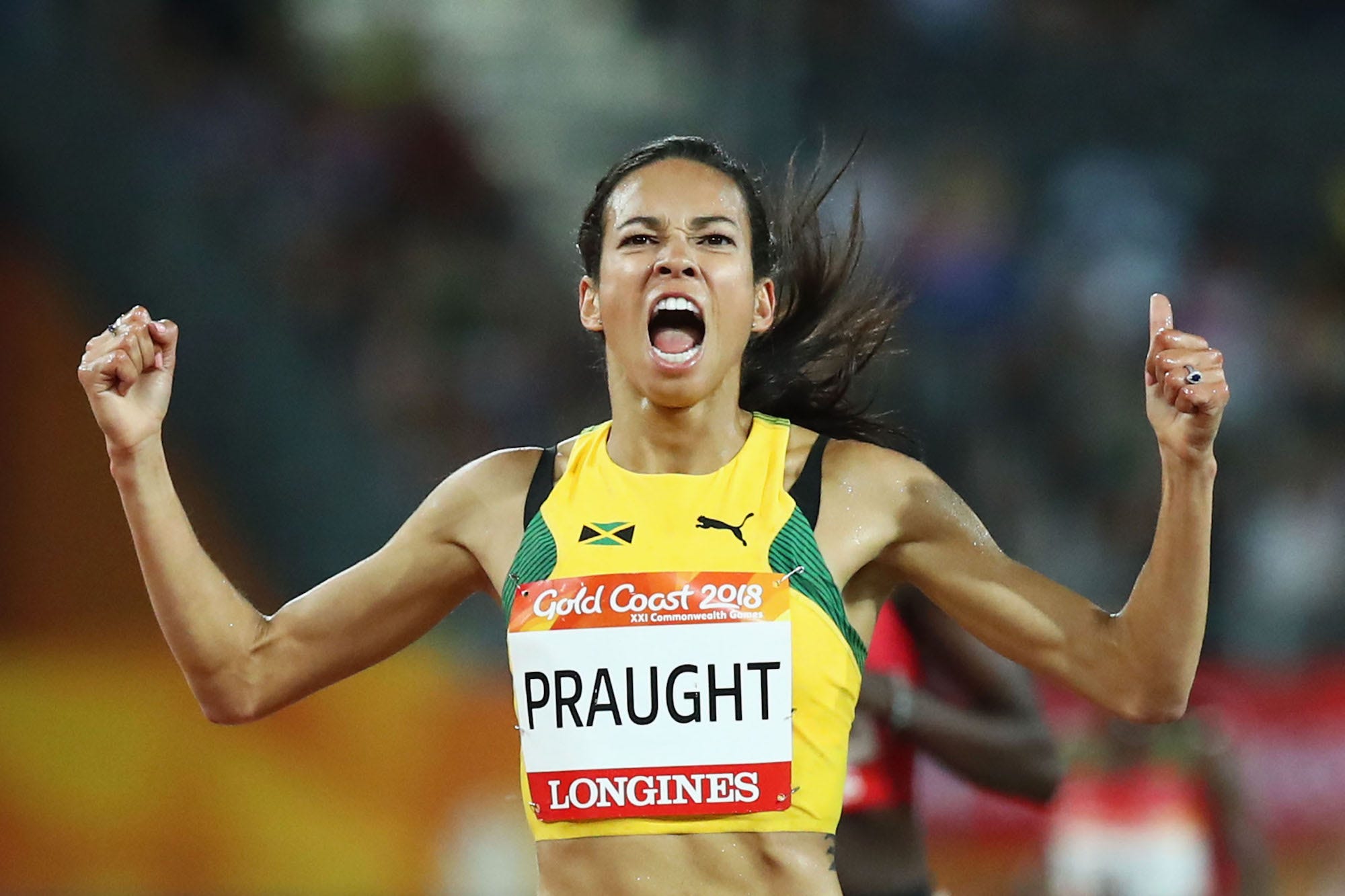 Aisha Praught of Jamaica celebrates as she crosses the line to win gold in the Women's 3000 metres Steeplechase final during athletics on day seven of the Gold Coast 2018 Commonwealth Games at Carrara Stadium