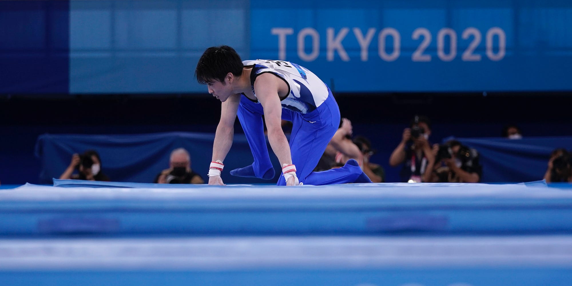 Kohei Uchimura on his hands and knees after falling at the Tokyo Olympics.