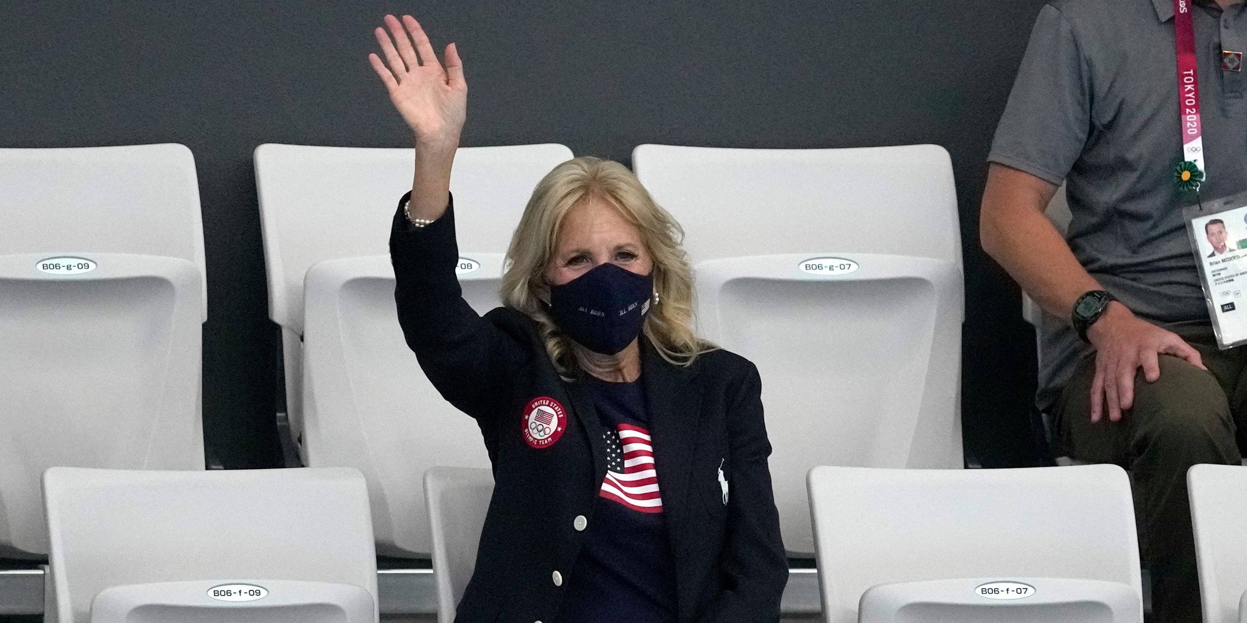 First lady of the United States, Jill Biden waves during a swimming event at Olympics.