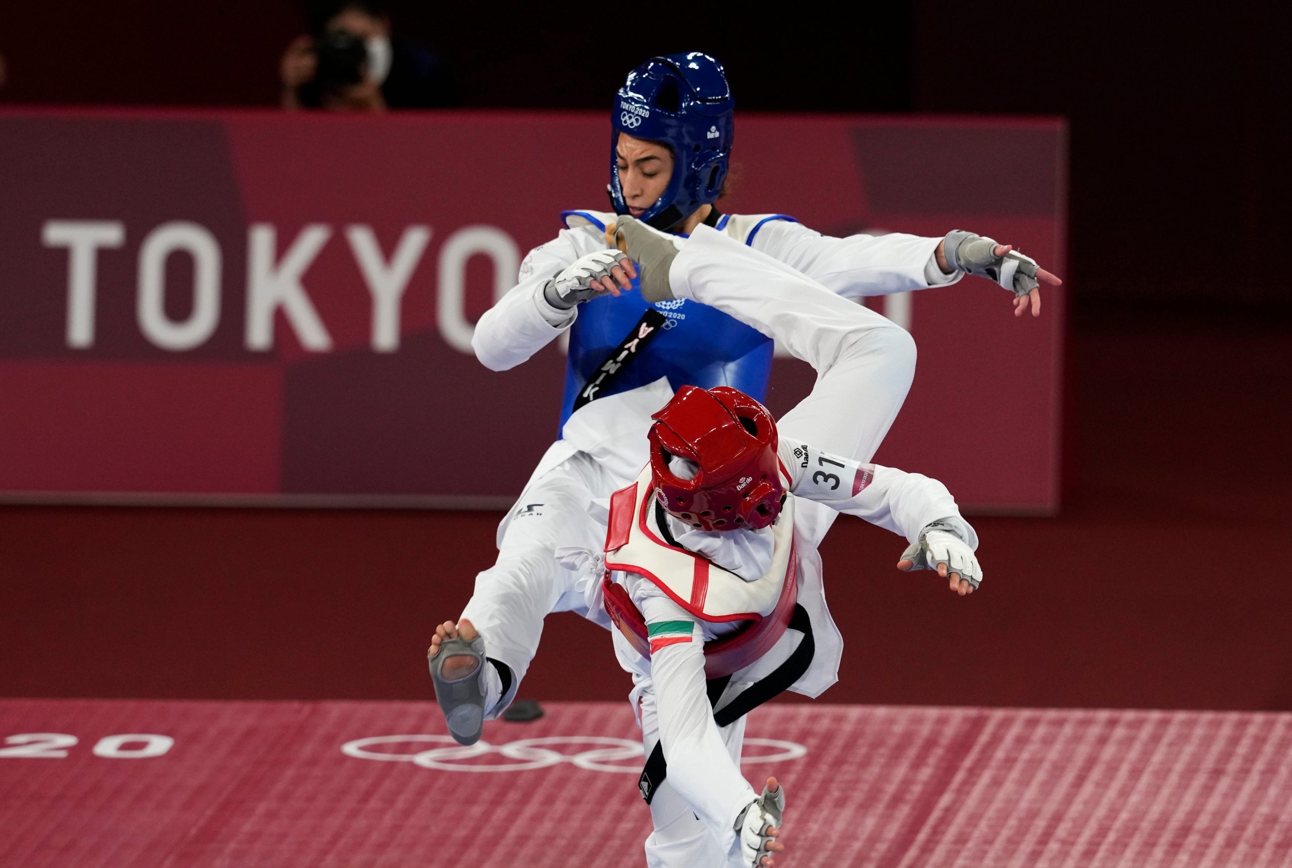 Iran's Nahid Kiyani, front, attacks Kimia Alizadeh, of the Refugee Olympic Team, during the women's 57kg match at the 2020 Summer Olympics, Sunday, July 25, 2021, in Tokyo, Japan.