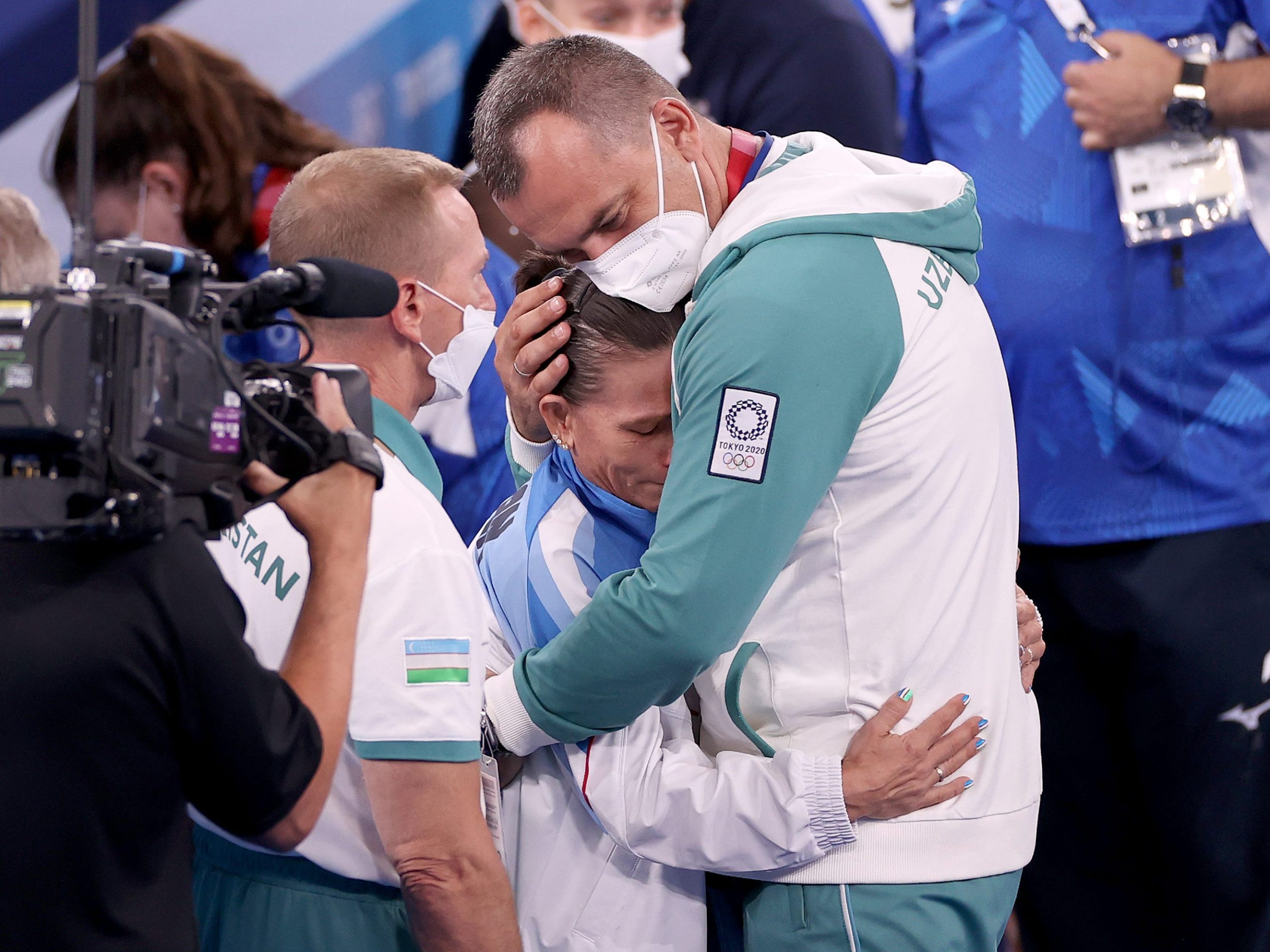 Oksana Chusovitina of Team Uzbekistan hugs her coach after competing on vault during Women's Qualification.