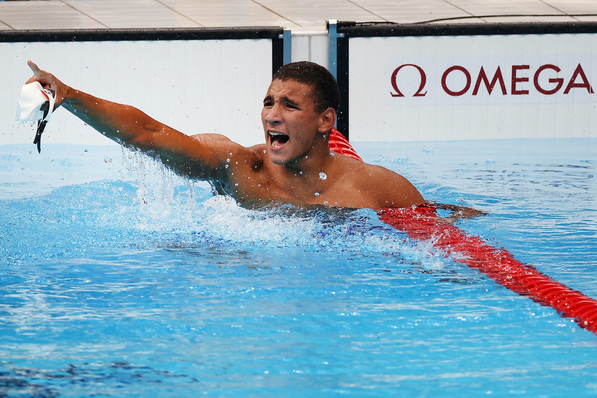 Tunisian swimmer Ahmed Hafnaoui celebrates winning his Olympic gold.