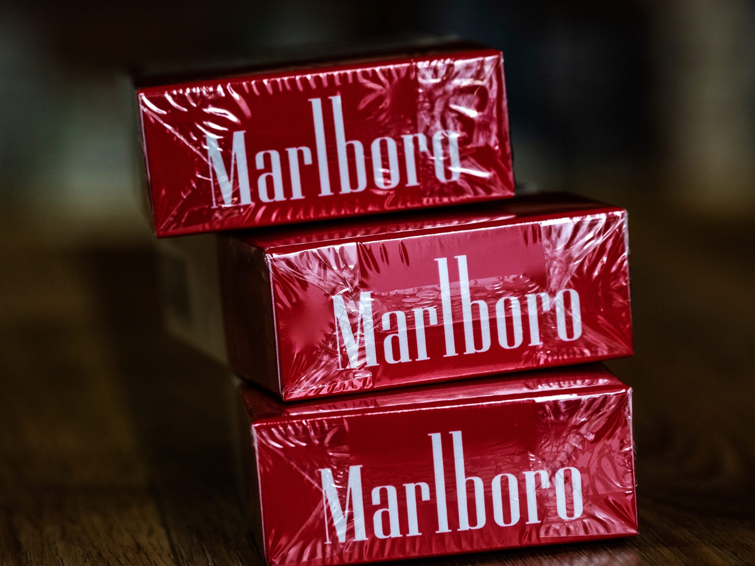 Three red packs of Marlboro cigarettes.