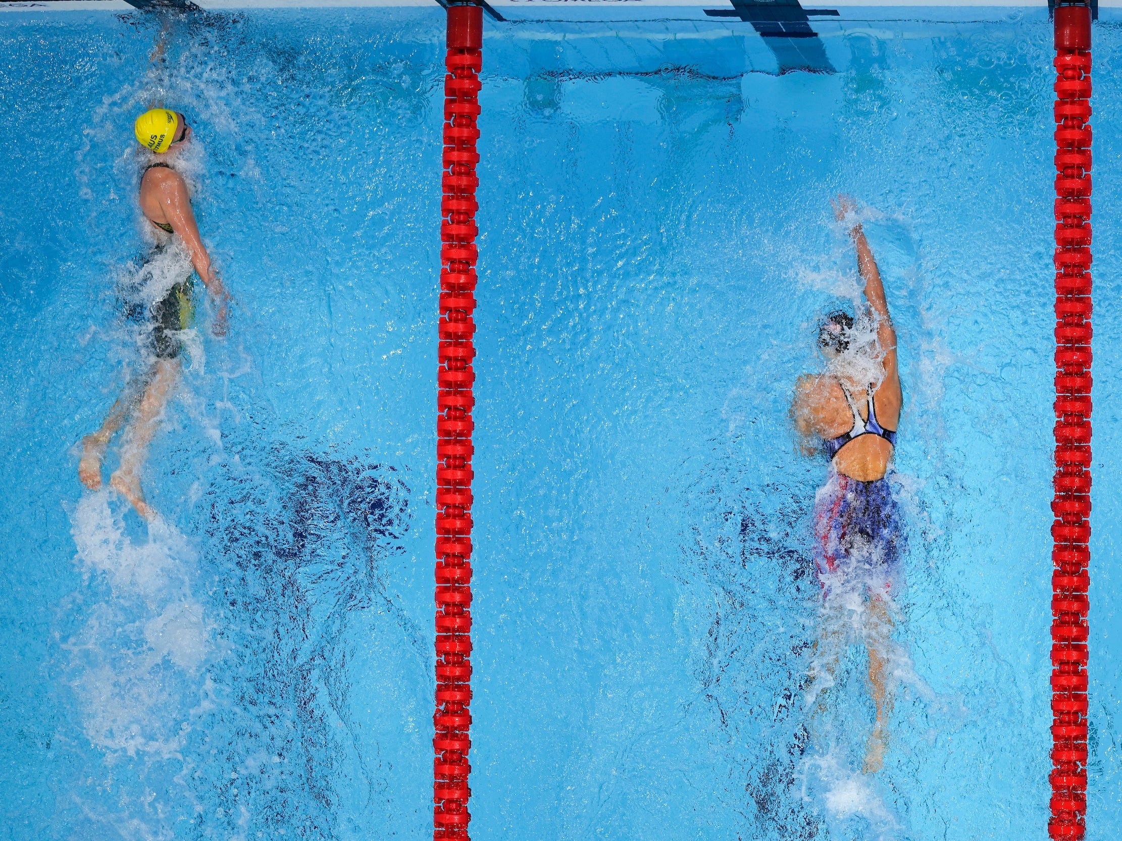Ariarne Titmus (left) touches the wall ahead of Katie Ledecky.