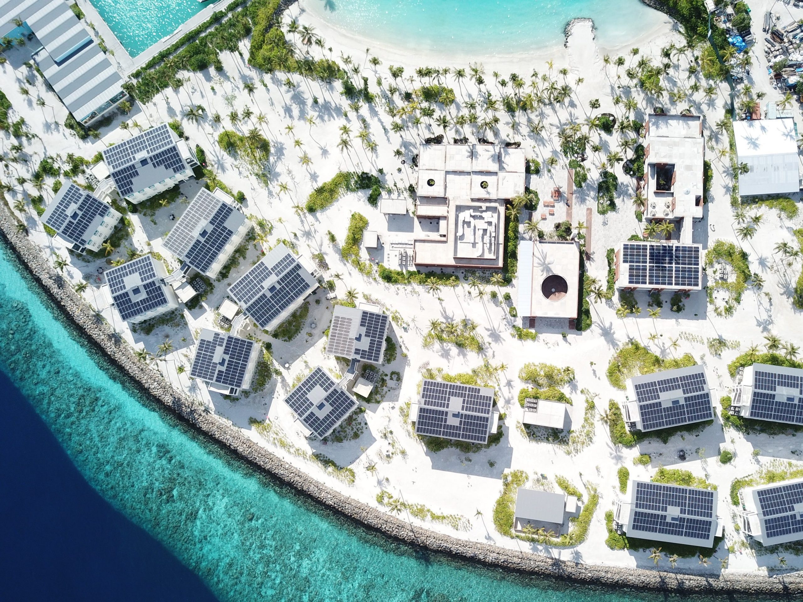 An ariel drone shot of Fari Campus shows staff buildings with seaviews.