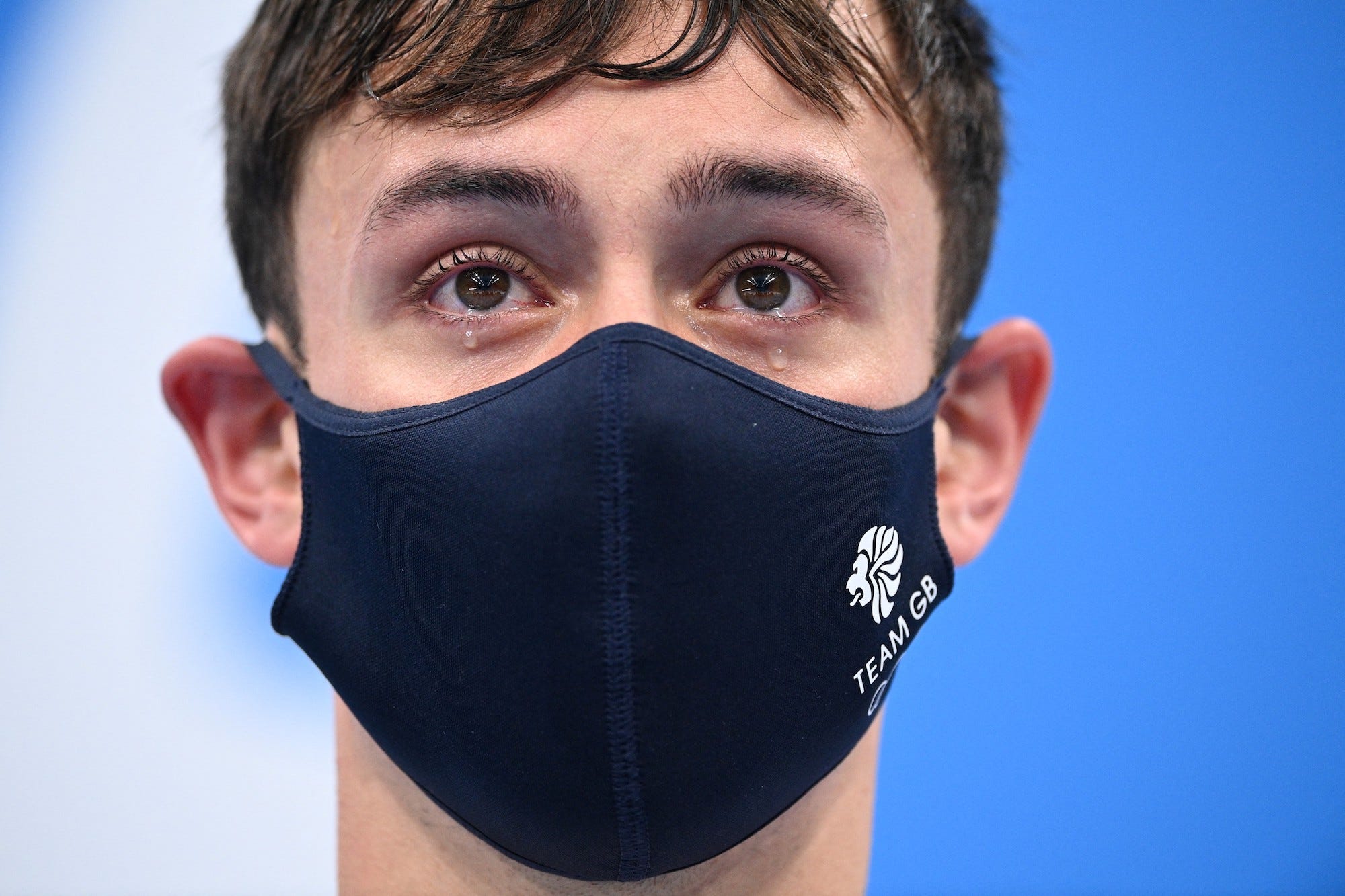 Britain's Thomas Daley and Britain's Matty Lee (unseen) as they wait to receive their medals after wining the men's synchronised 10m platform diving final event during the Tokyo 2020 Olympic Games at the Tokyo Aquatics Centre