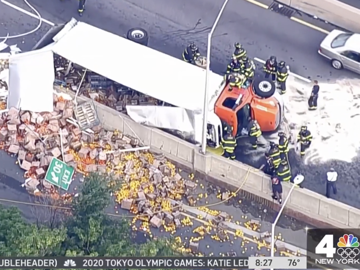 Overturned truck on the Brooklyn-Queens Expressway next to spilled haul of vegetables.