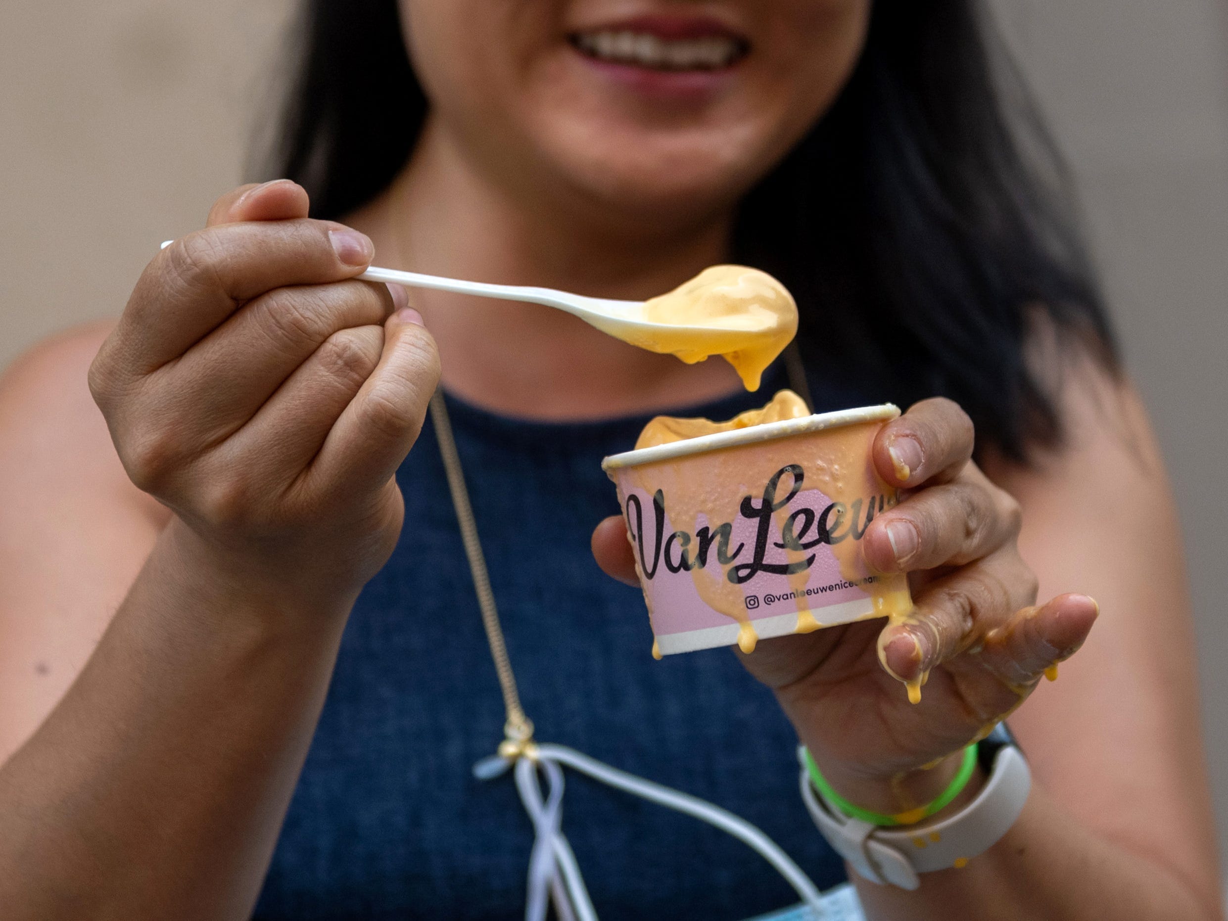 Woman holding cup of Kraft mac and cheese ice cream