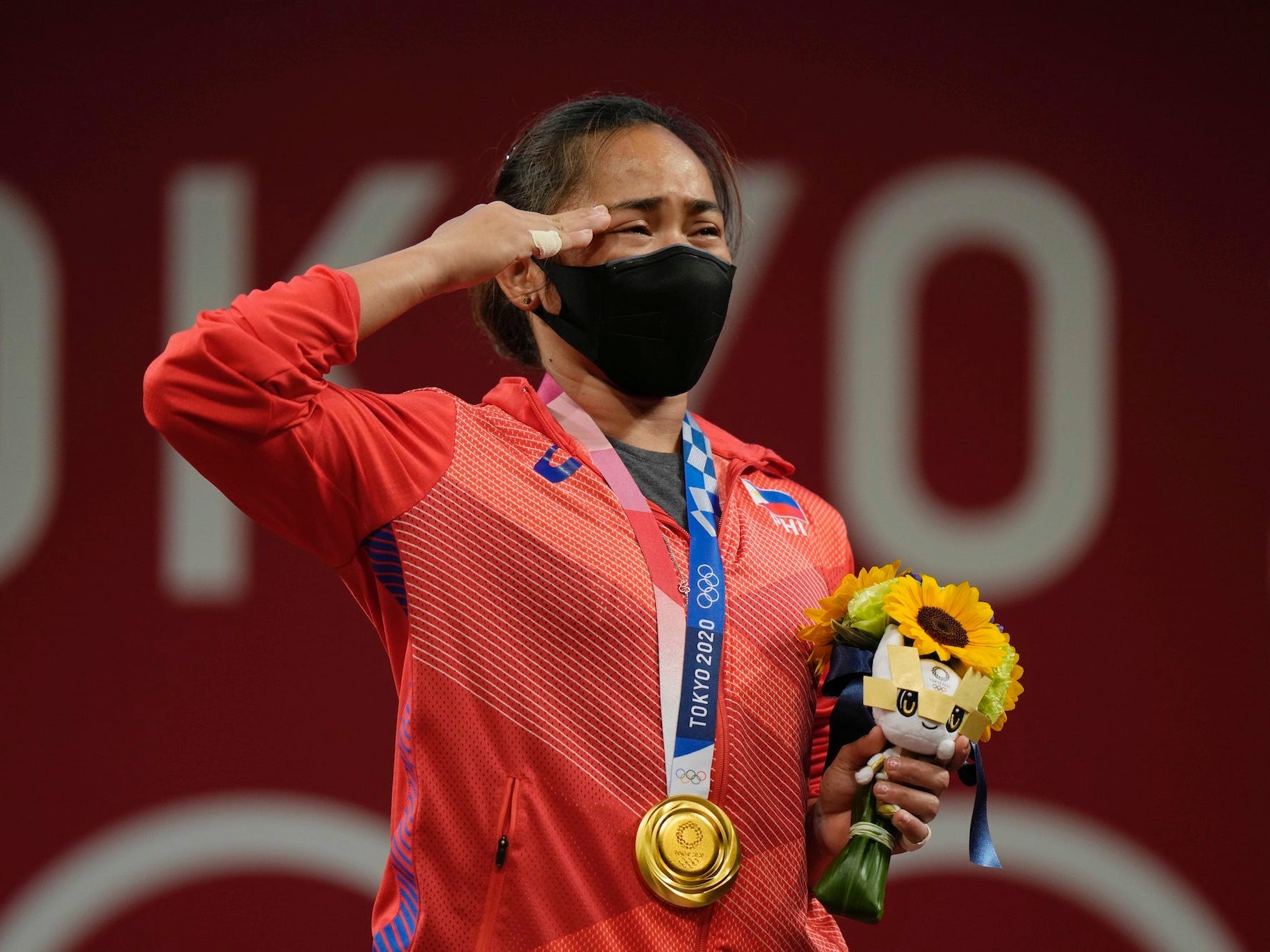 Hidilyn Diaz salutes during the Tokyo Olympics medal ceremony.