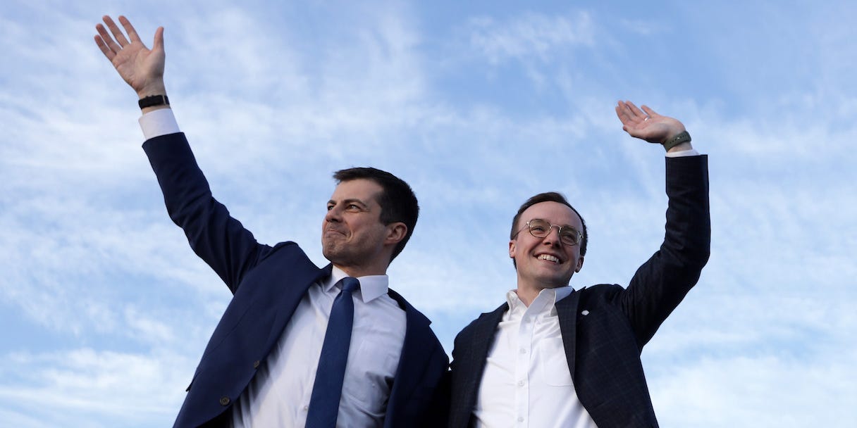 Transportation Secretary Pete Buttigieg and his husband Chasten Buttigieg wave during a campaign stop in 2020.