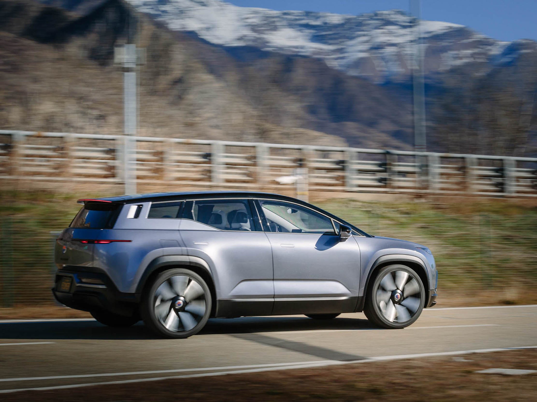 The Fisker Ocean SUV drives along a road