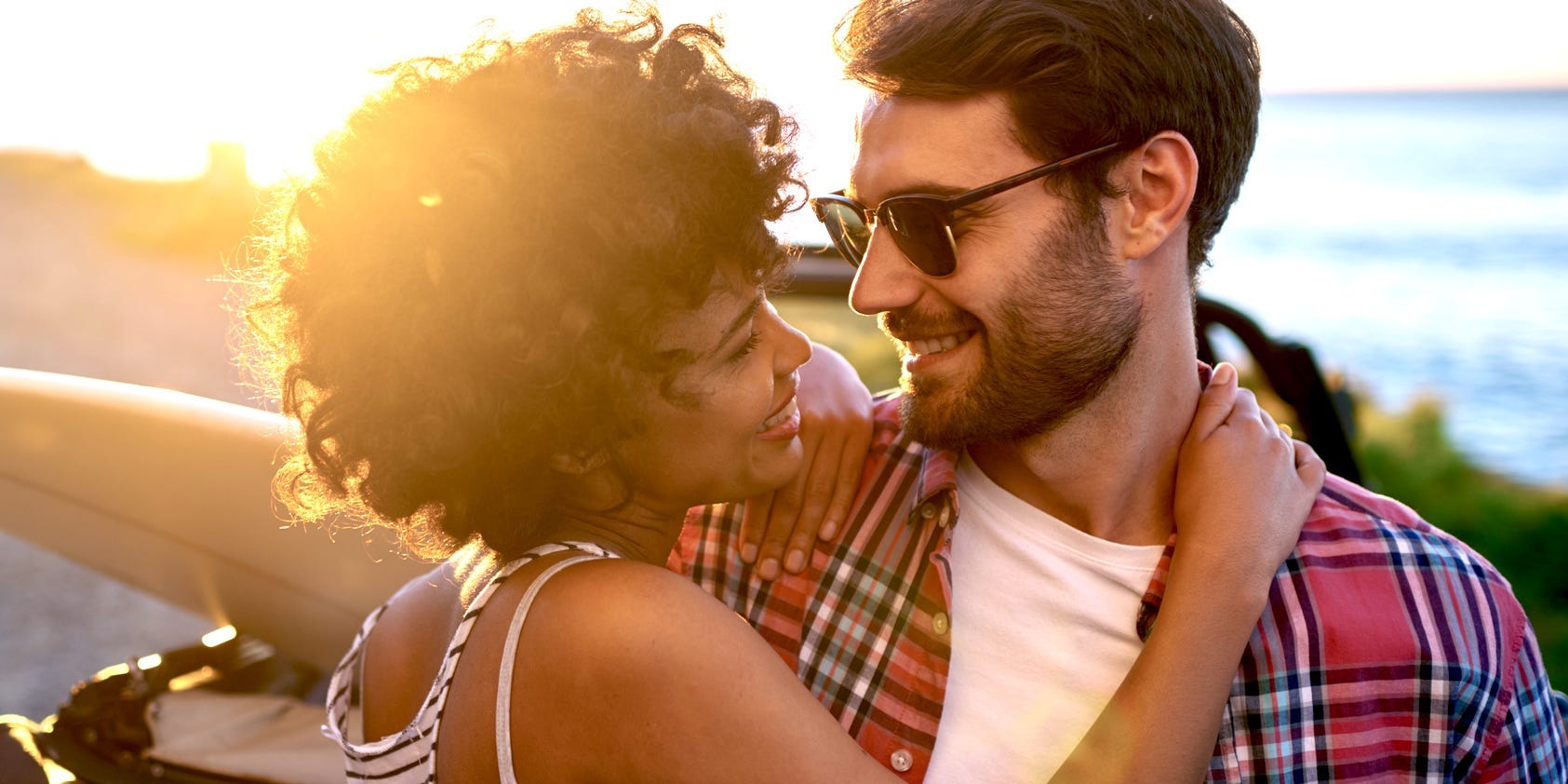 bi-racial couple surfing and being in love