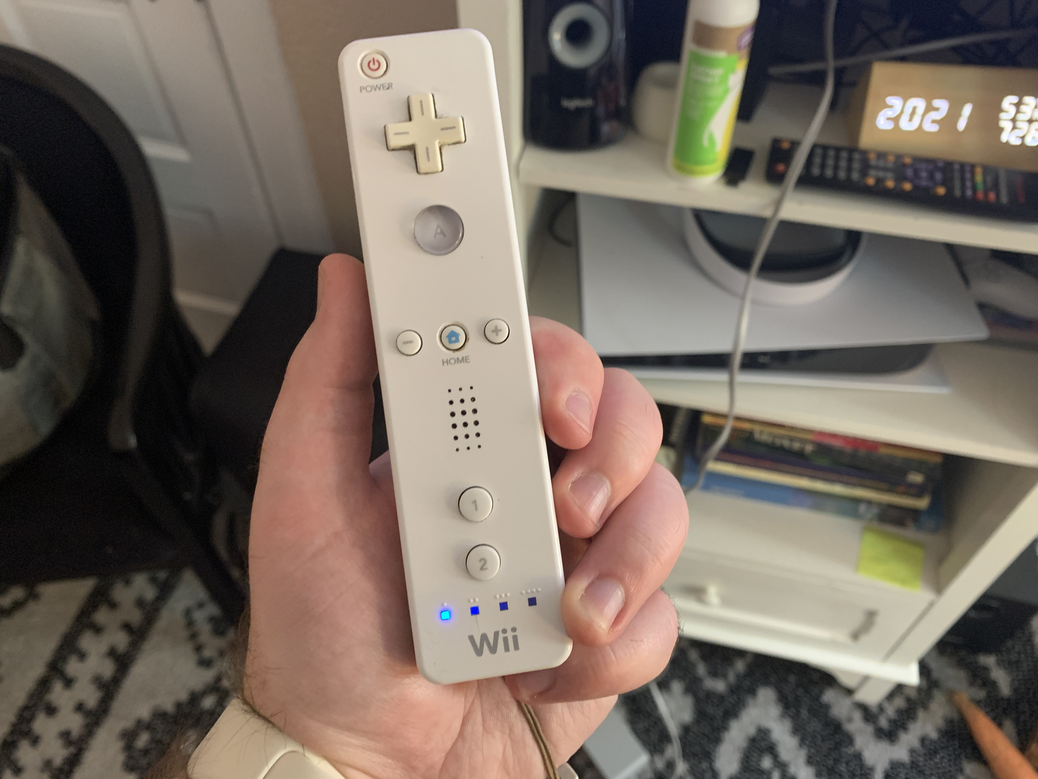 A Wii Remote. One light is illuminated at the bottom.