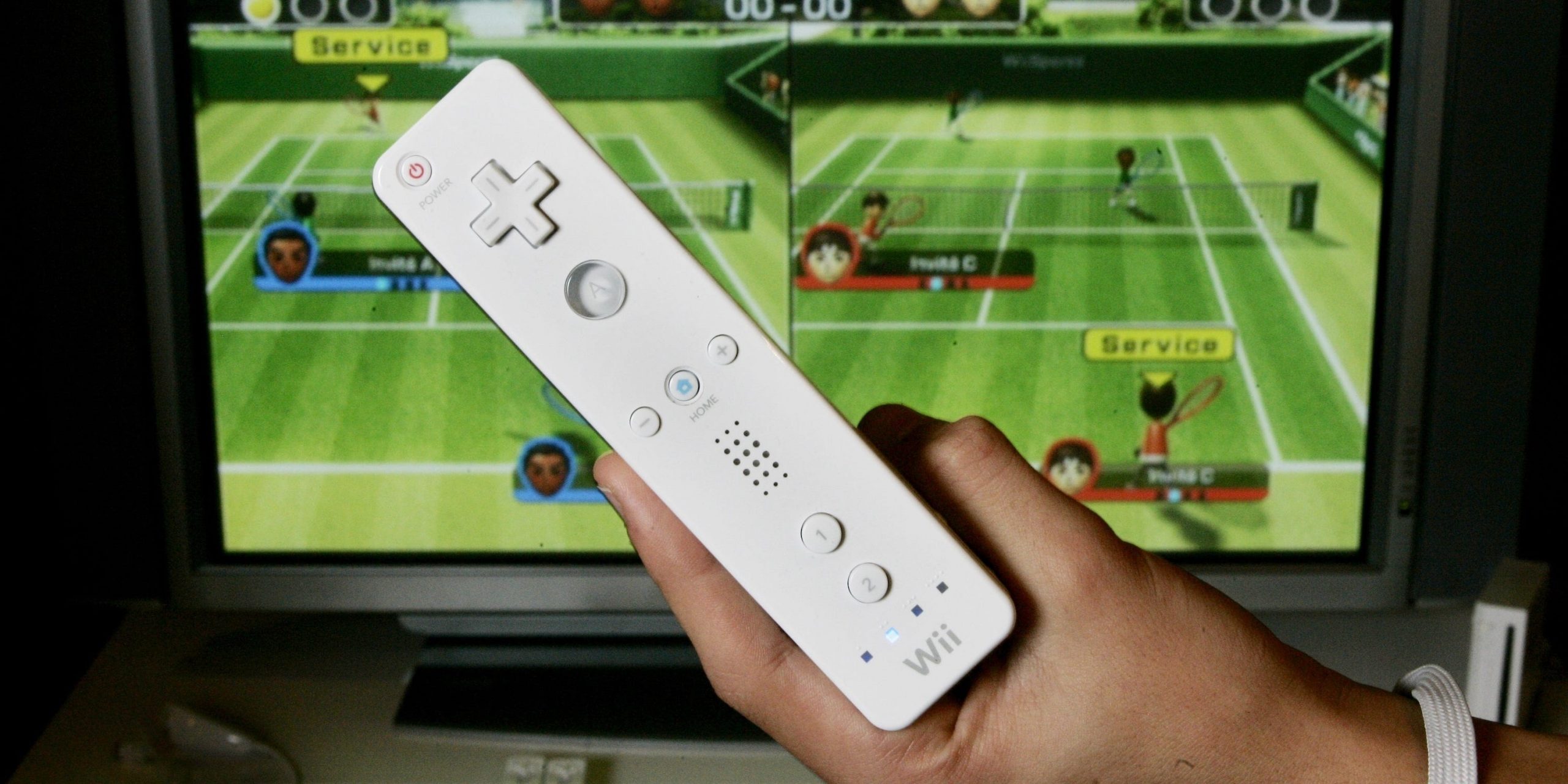 A Wii Remote and a TV playing Wii Sports.