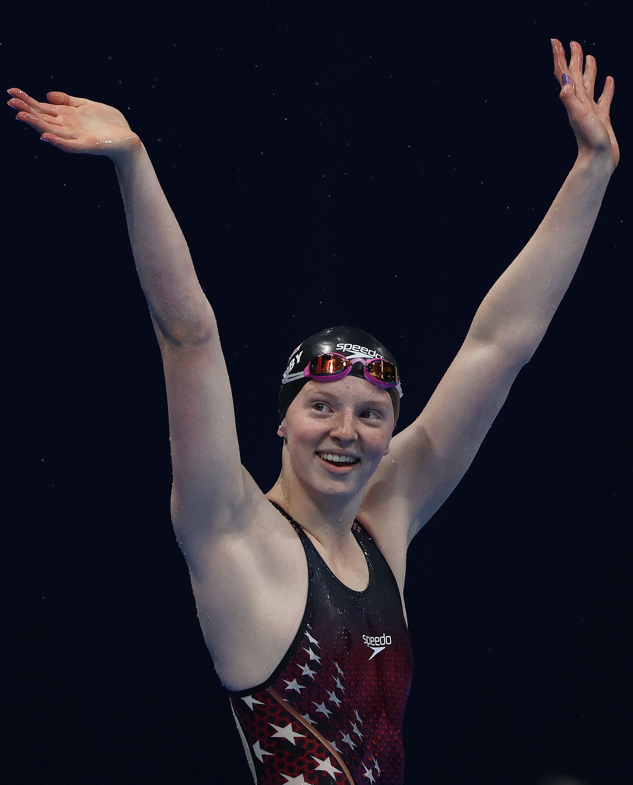 Lydia Jacoby is pictured waving to spectators after winning gold in the 100 meter breastroke final at the Tokyo Olympics.