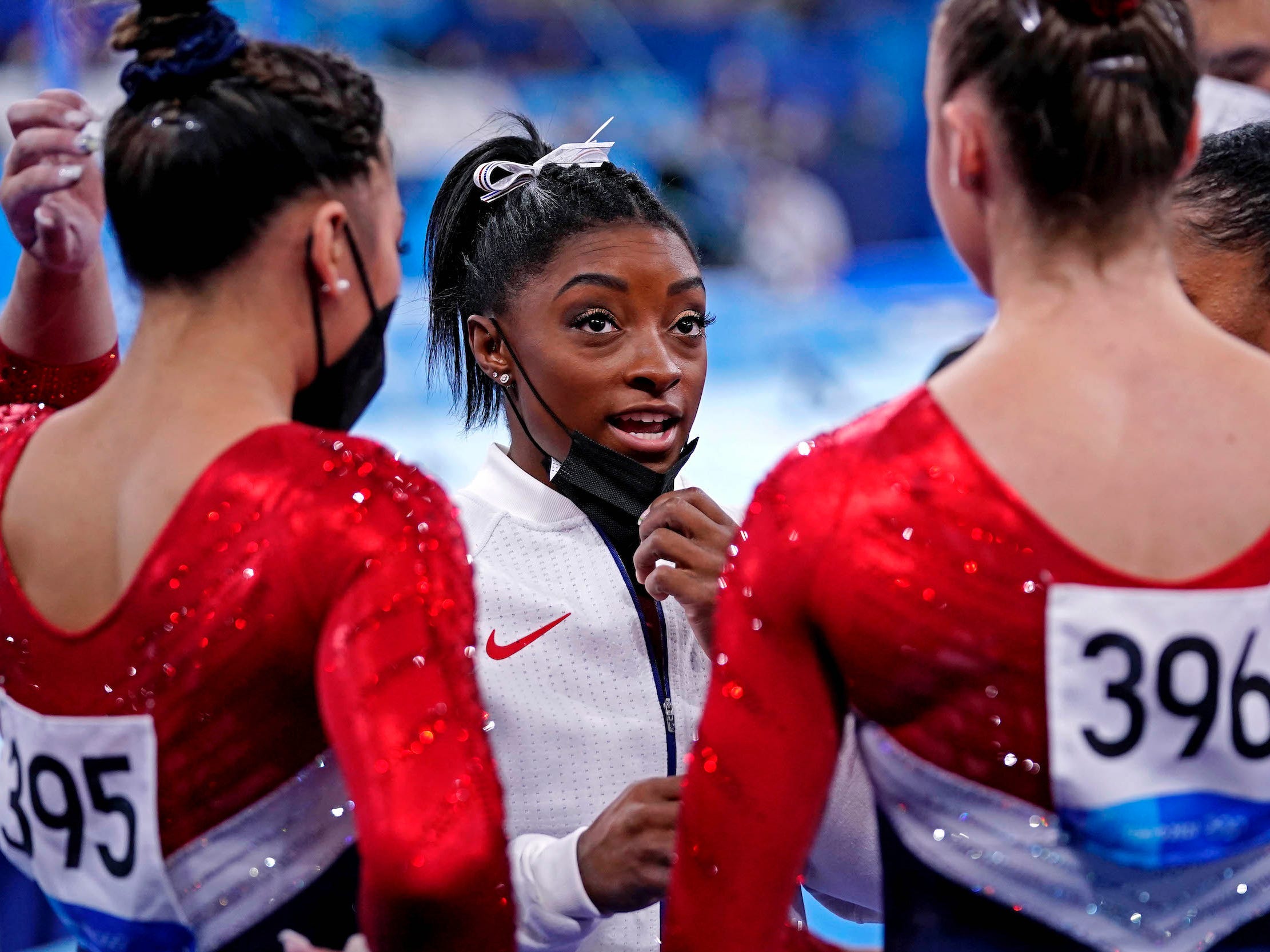 Simone Biles chats with her Team USA teammates.