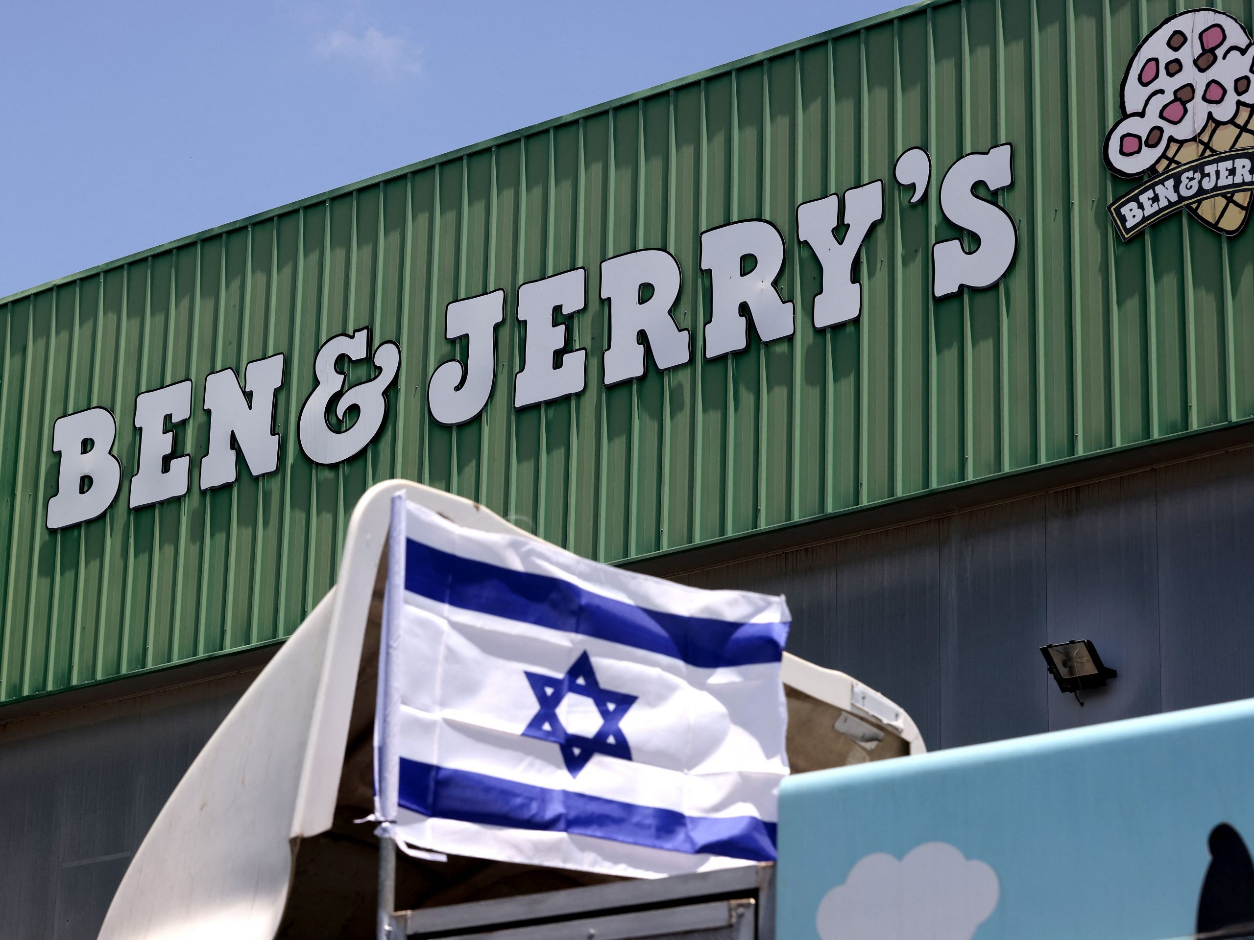 An Israeli flag is set atop a delivery truck outside US ice-cream maker Ben & Jerry's factory in Be'er Tuvia, on July 21, 2021