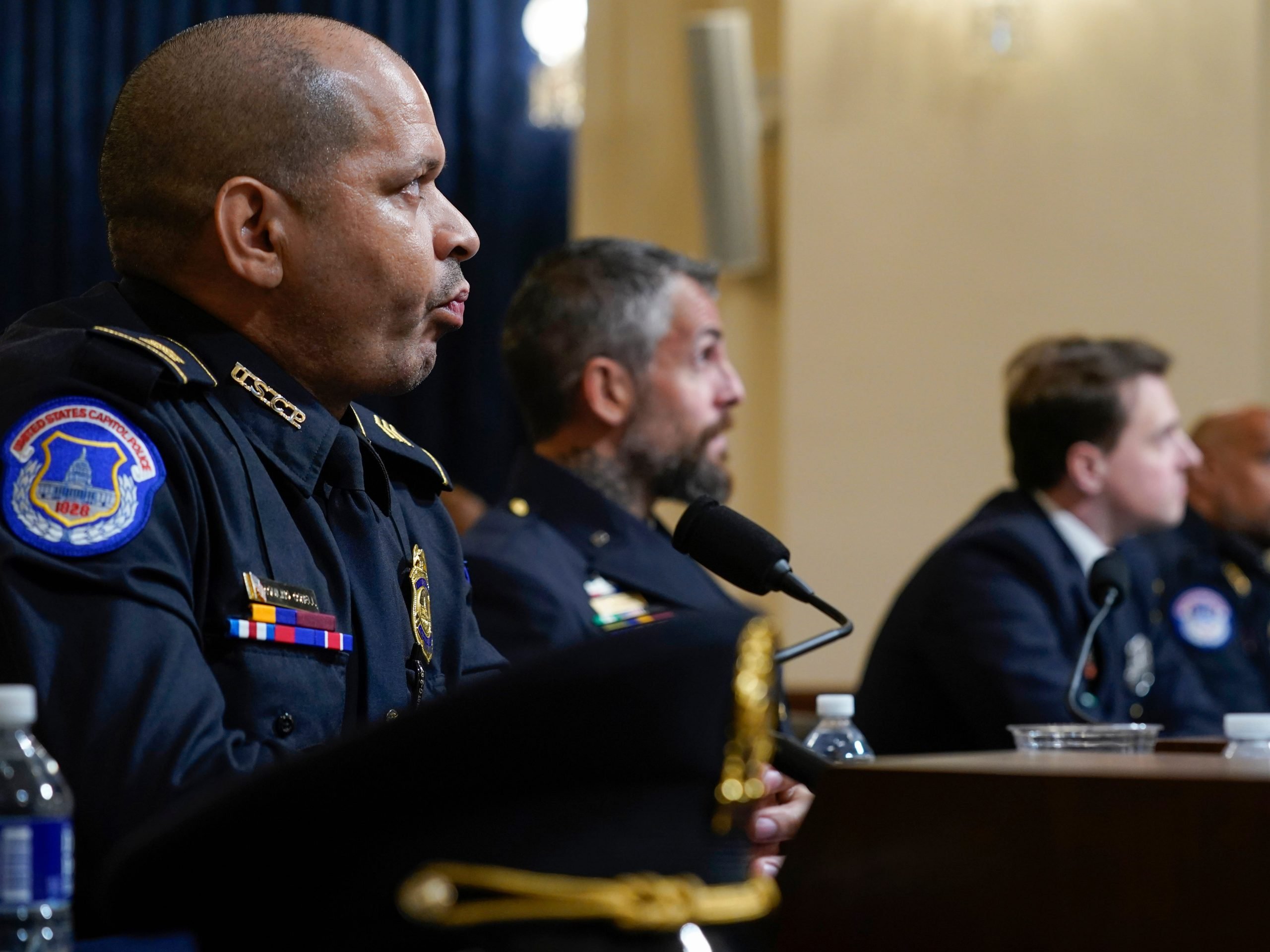 US Capitol Police Sgt. Aquilino Gonell, Washington Metropolitan Police Department officer Michael Fanone, Washington Metropolitan Police Department officer Daniel Hodges and US Capitol Police Sgt. Harry Dunn watch a video of rioters during the House Select Committee investigating the January 6 attack on the US Capitol on July 27, 2021 at the Cannon House Office Building in Washington, DC.