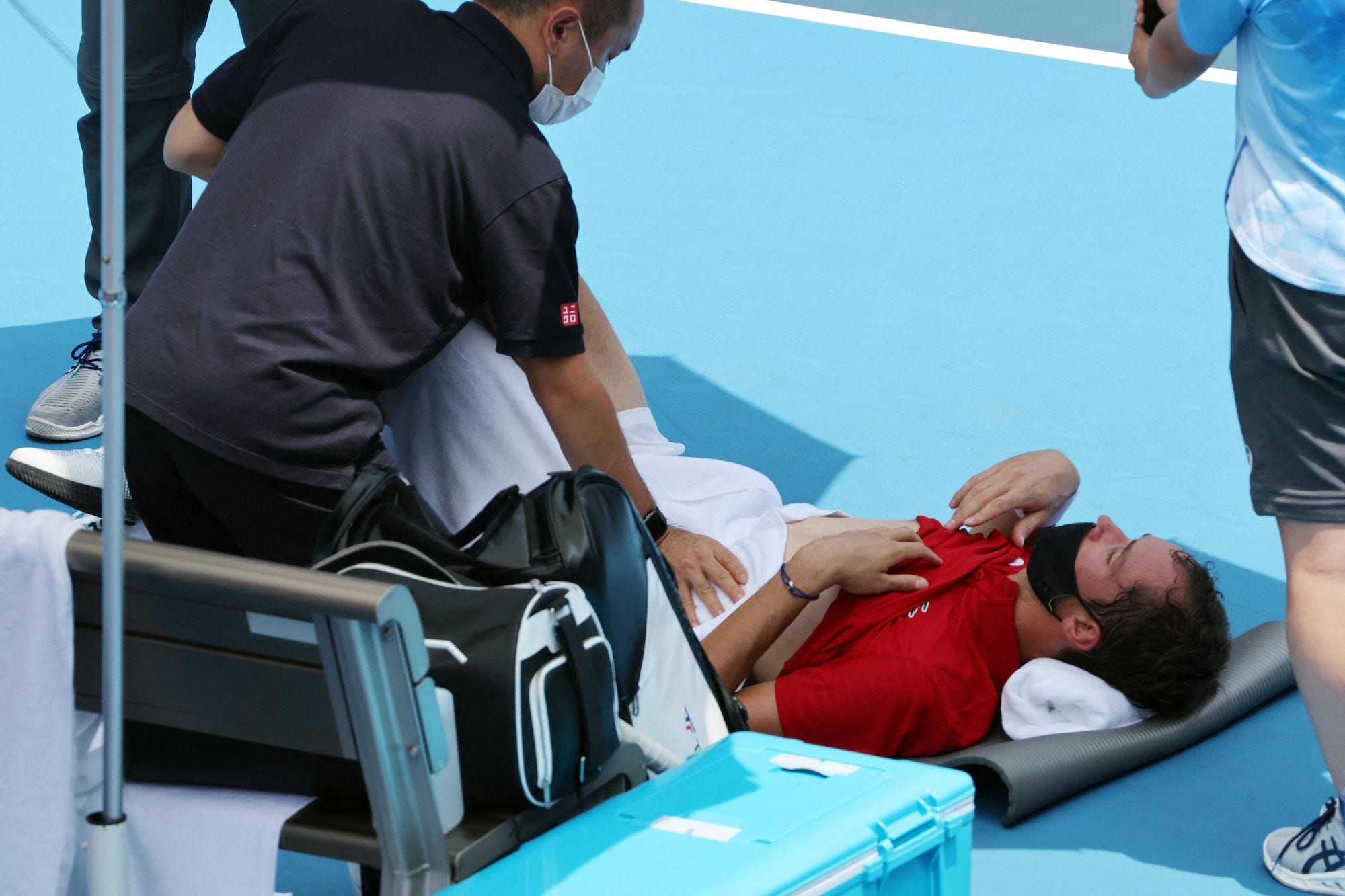 Daniil Medvedev lies down as he's concerned he'll die from the heat while on court during the Olympic Games.
