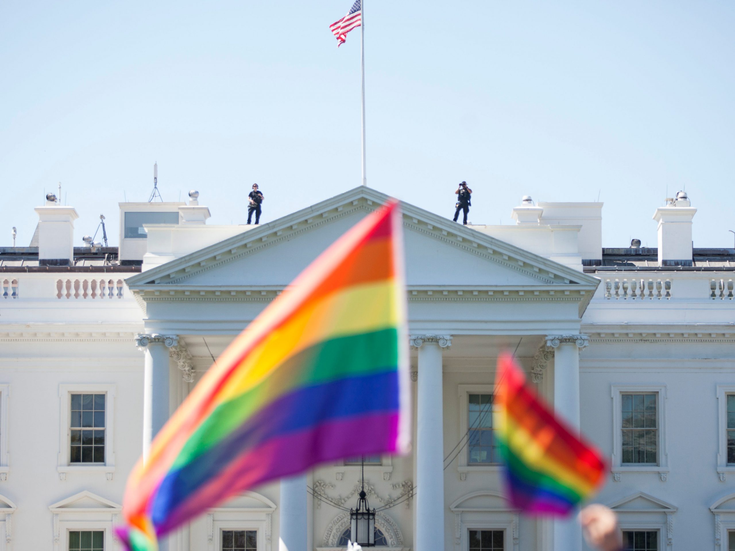 Demonstrators carry rainbow flags past the White House during the Equality March for Unity and Peace on June 11, 2017 in Washington, D.C.