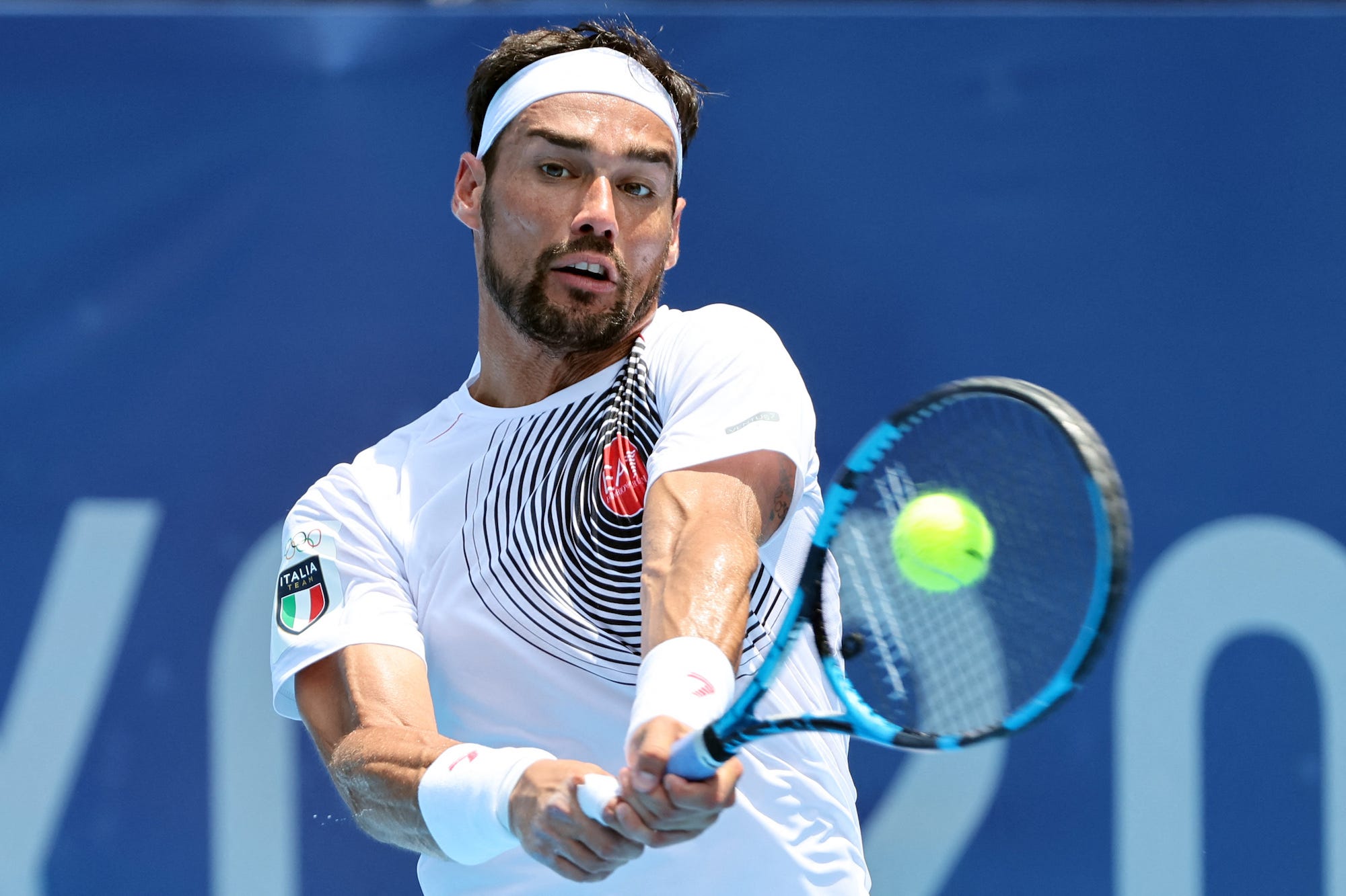 Italy's Fabio Fognini returns the ball to Russia's Daniil Medvedev during their Tokyo 2020 Olympic Games men's singles third round tennis match at the Ariake Tennis Park in Tokyo